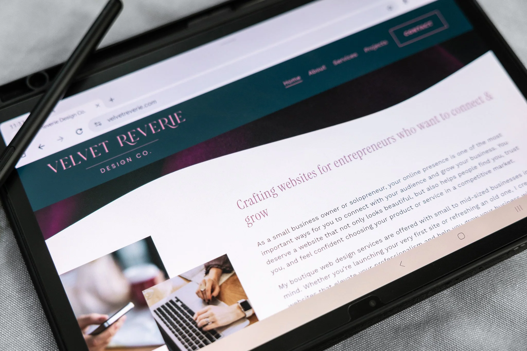 Samsung tablet displaying a website horizontally with stylus sitting on top