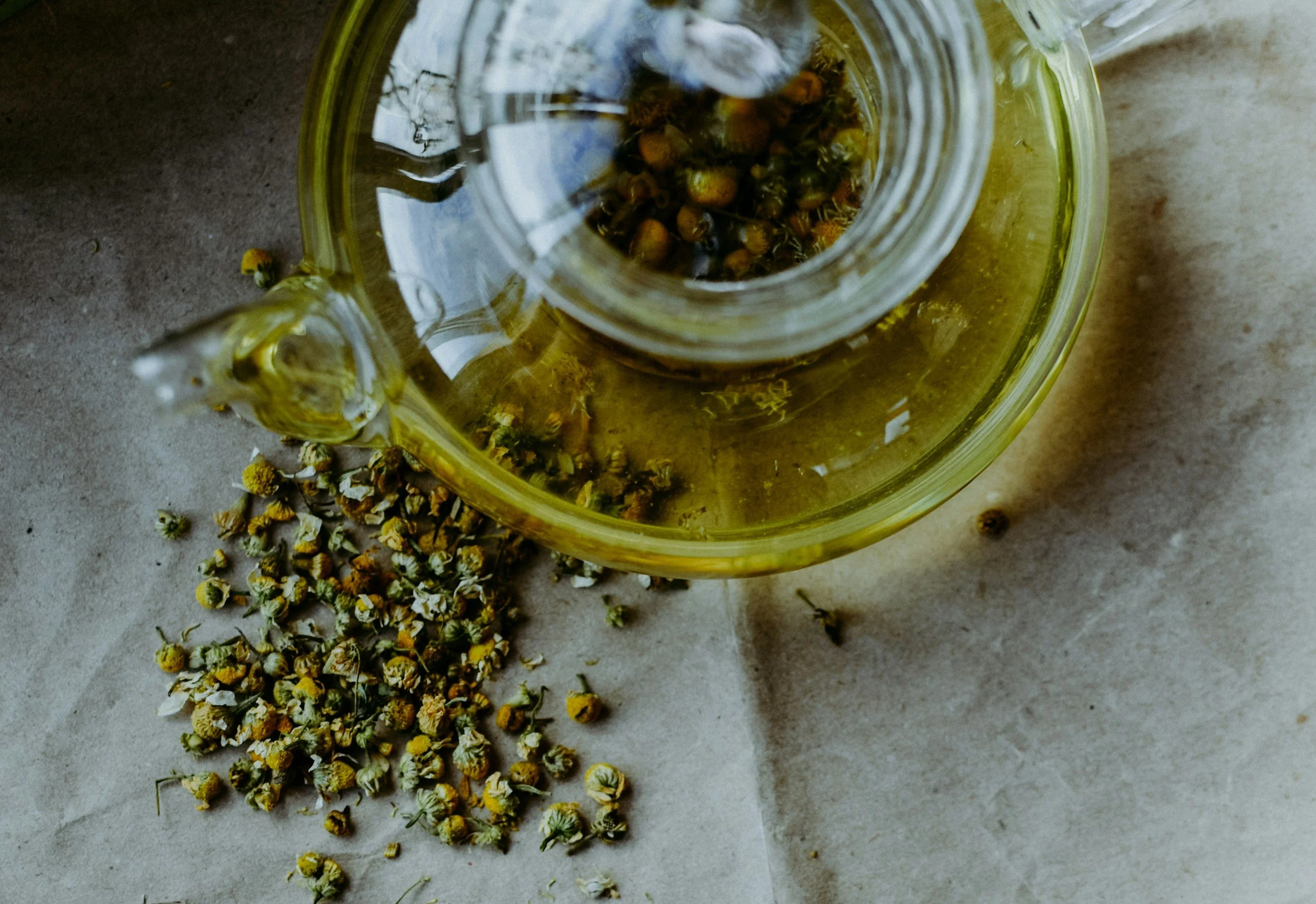 Chamomile tea in glass teapot for overwhelm & anxiety relief