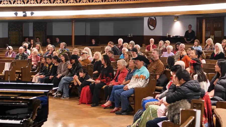 Restored church audience behind piano.webp