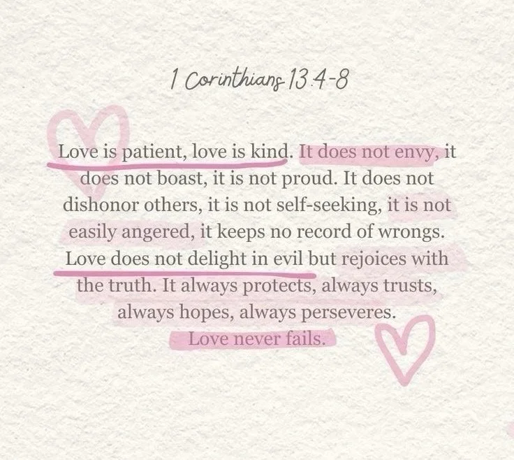 A handwritten note with a Bible verse from 1 Corinthians 13:4-8. The text emphasizes love's patience, kindness, and permanence, with certain phrases highlighted in pink and accompanied by pink heart illustrations.