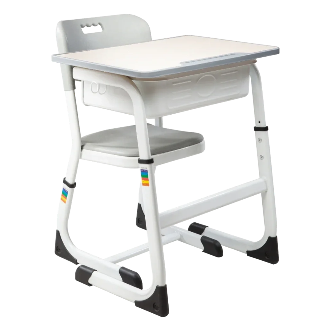White children's school desk with attached chair, equipped with black and rainbow-colored accents on the legs, and a storage compartment underneath the desk surface.
