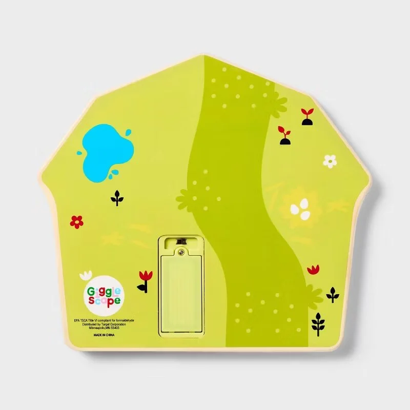 Colorful children's light switch cover with a nature-themed design featuring a stream, flowers, and plants. Developed for Target.