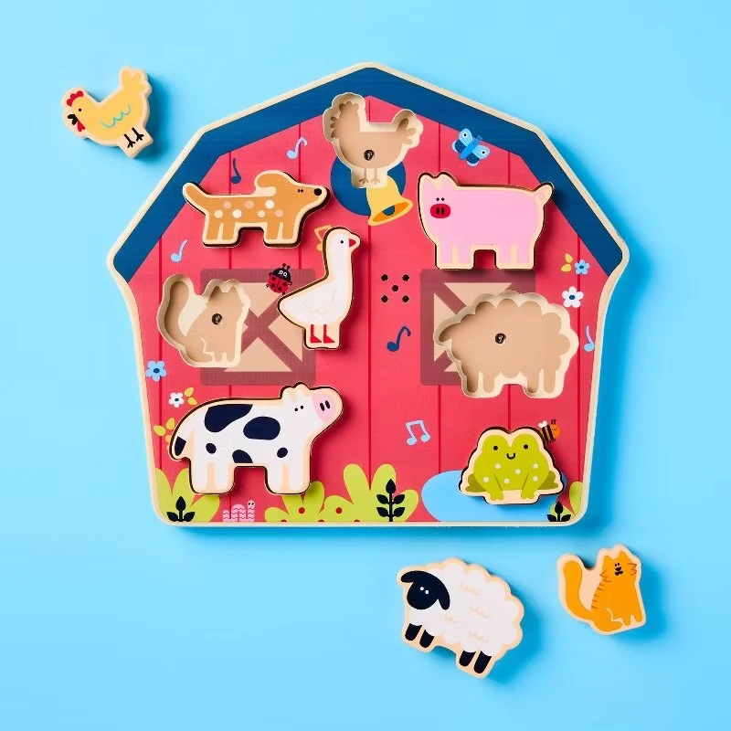 Colorful animal puzzle with farm animals and two magnetic pieces on a bright blue background. Developed for Target.