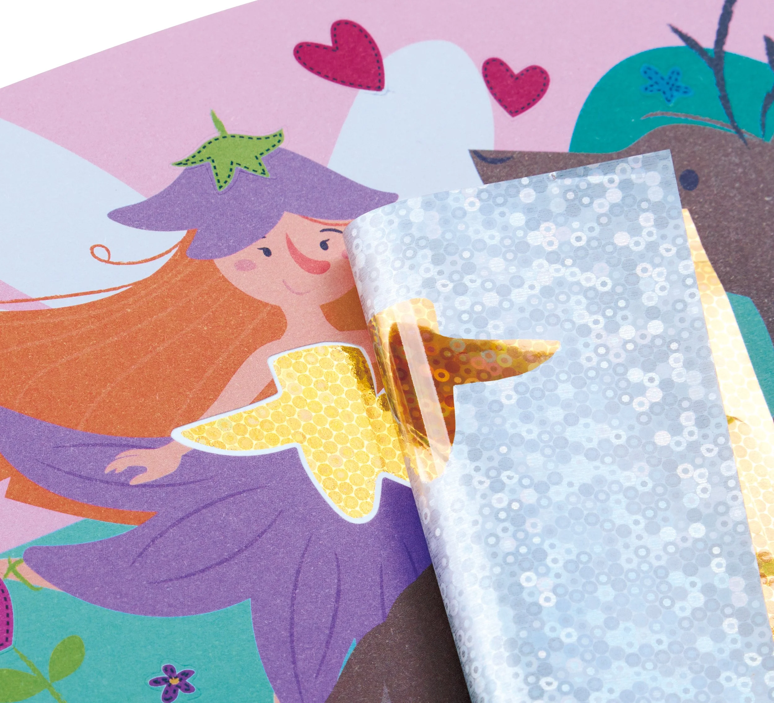A colorful illustration of a fairy with orange hair, a purple hat and a yellow dress, and a partially peeled sticker on top of the illustration.