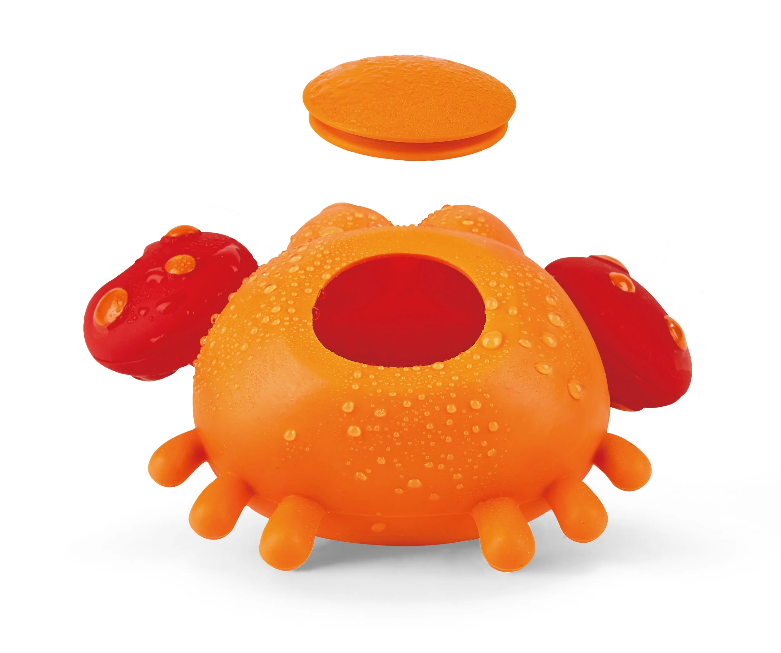 A toy crab from the "Hape bath toy" collection composed of orange and red plastic with a hollow body, water droplets on its surface, and a removable orange top, set against a white background.