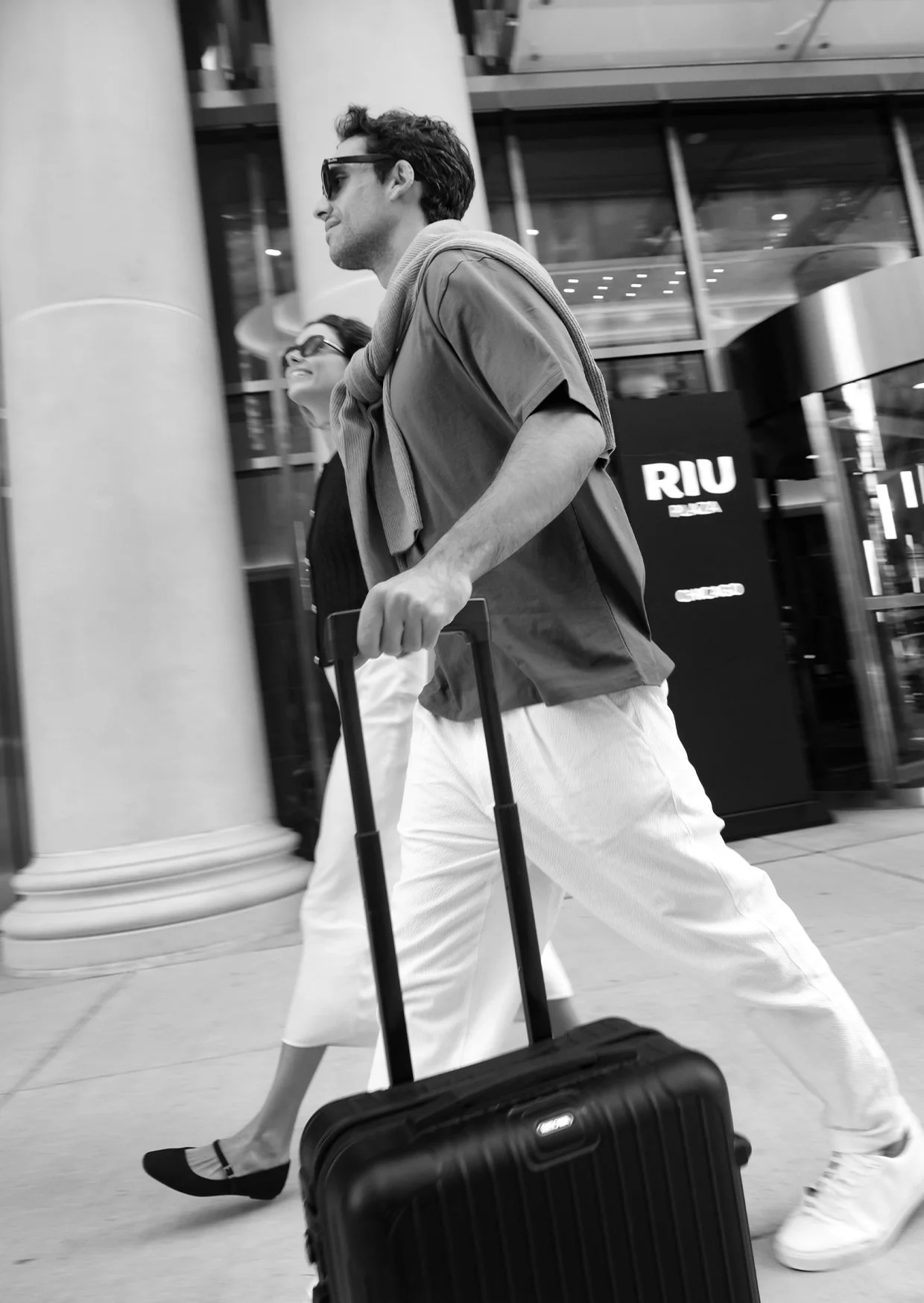 couple travelling with a wheeled suitcase.jpg
