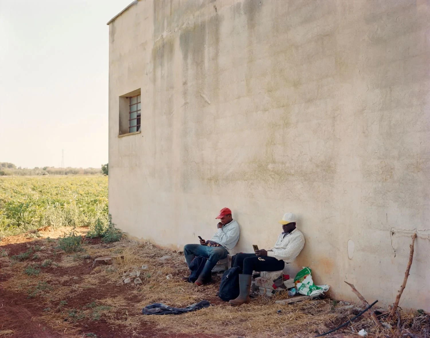 Sheriff and Moussa taking a break from working the land