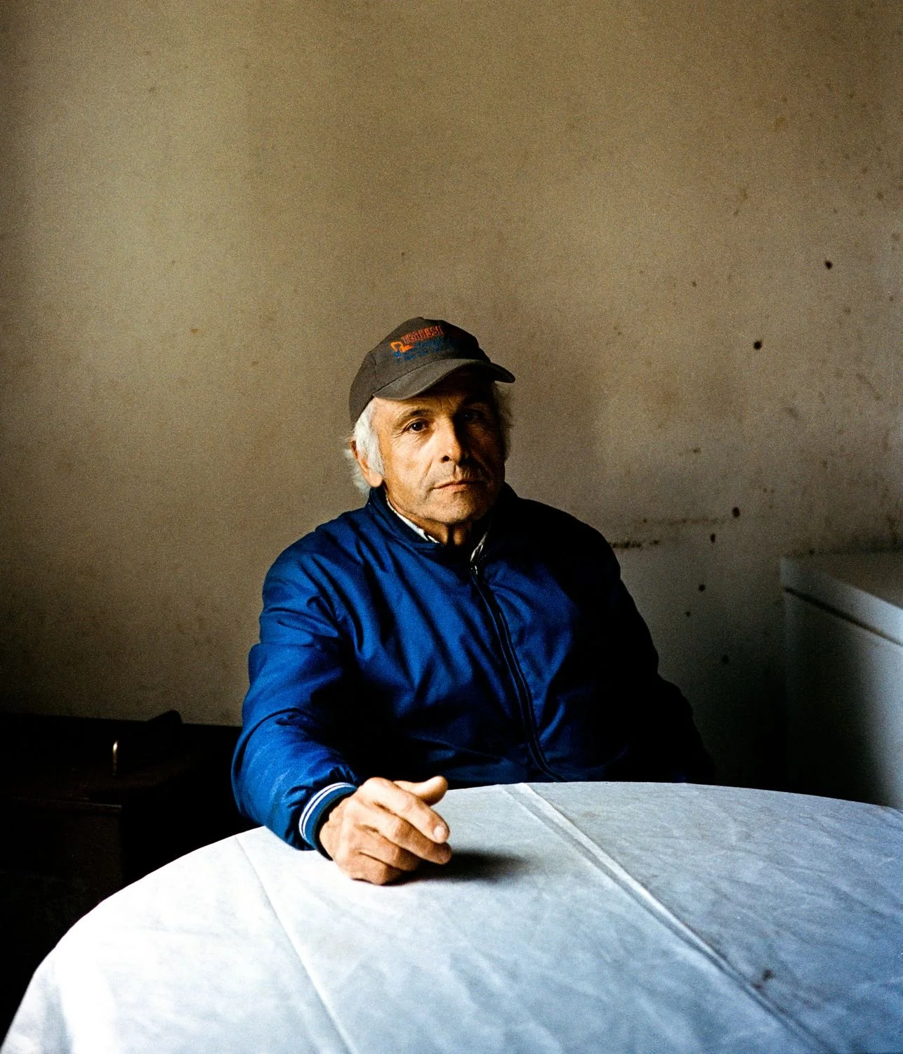 Adelino (64) in his living room. Miner from 1980 to 1992. Former miners’ quarter.