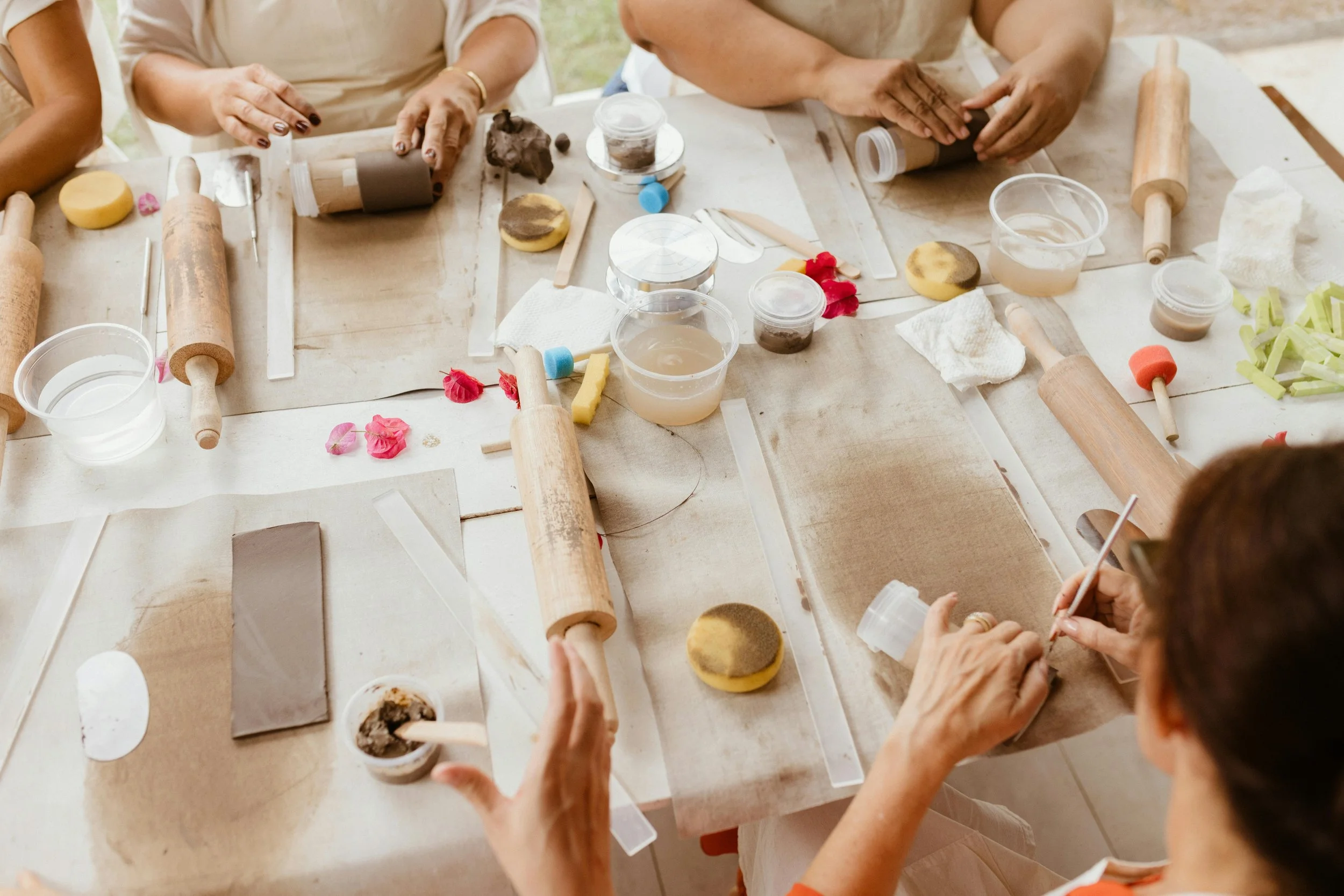team working together on table making handmade crafts