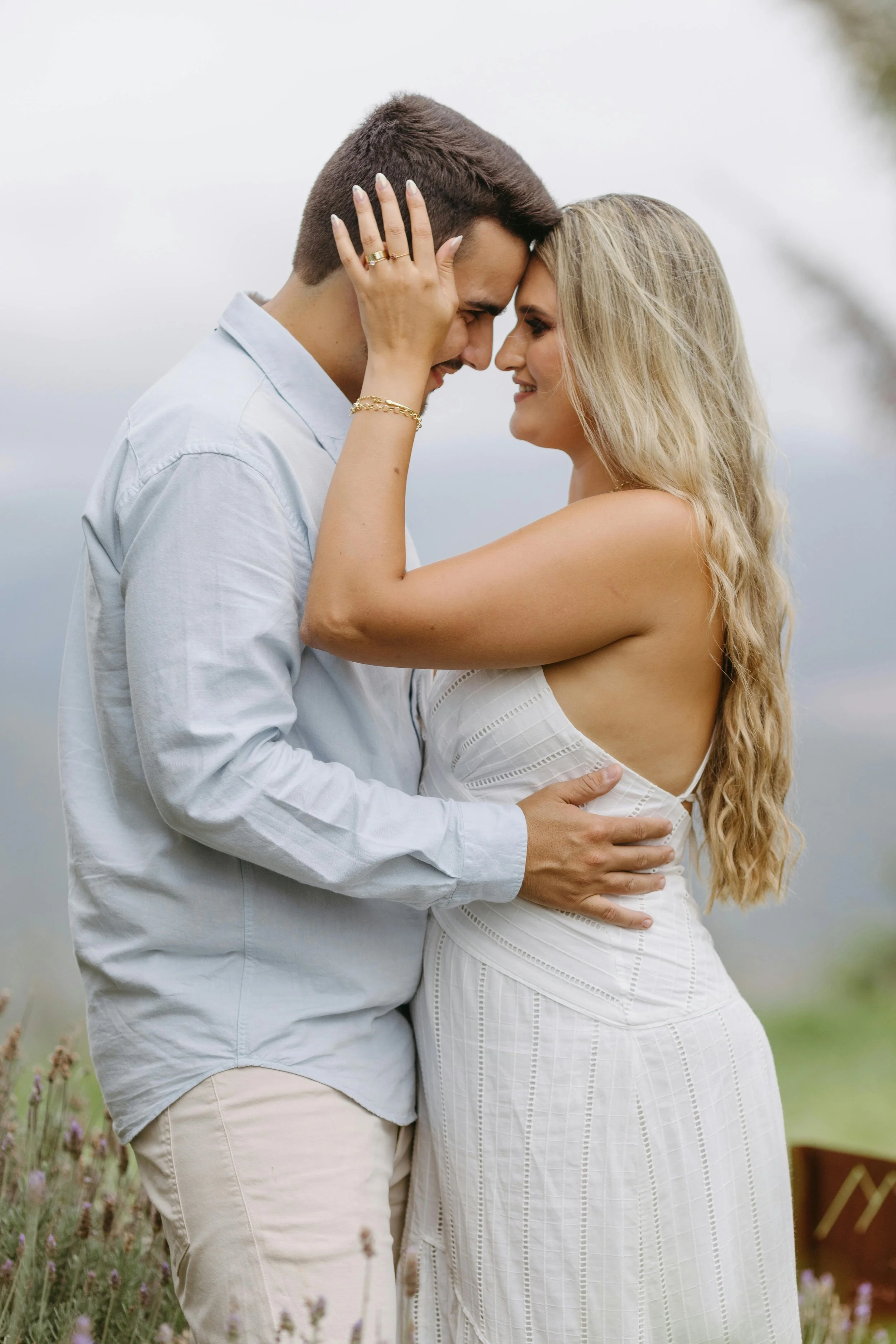 just engaged couple holding each other close and sharing an embrace