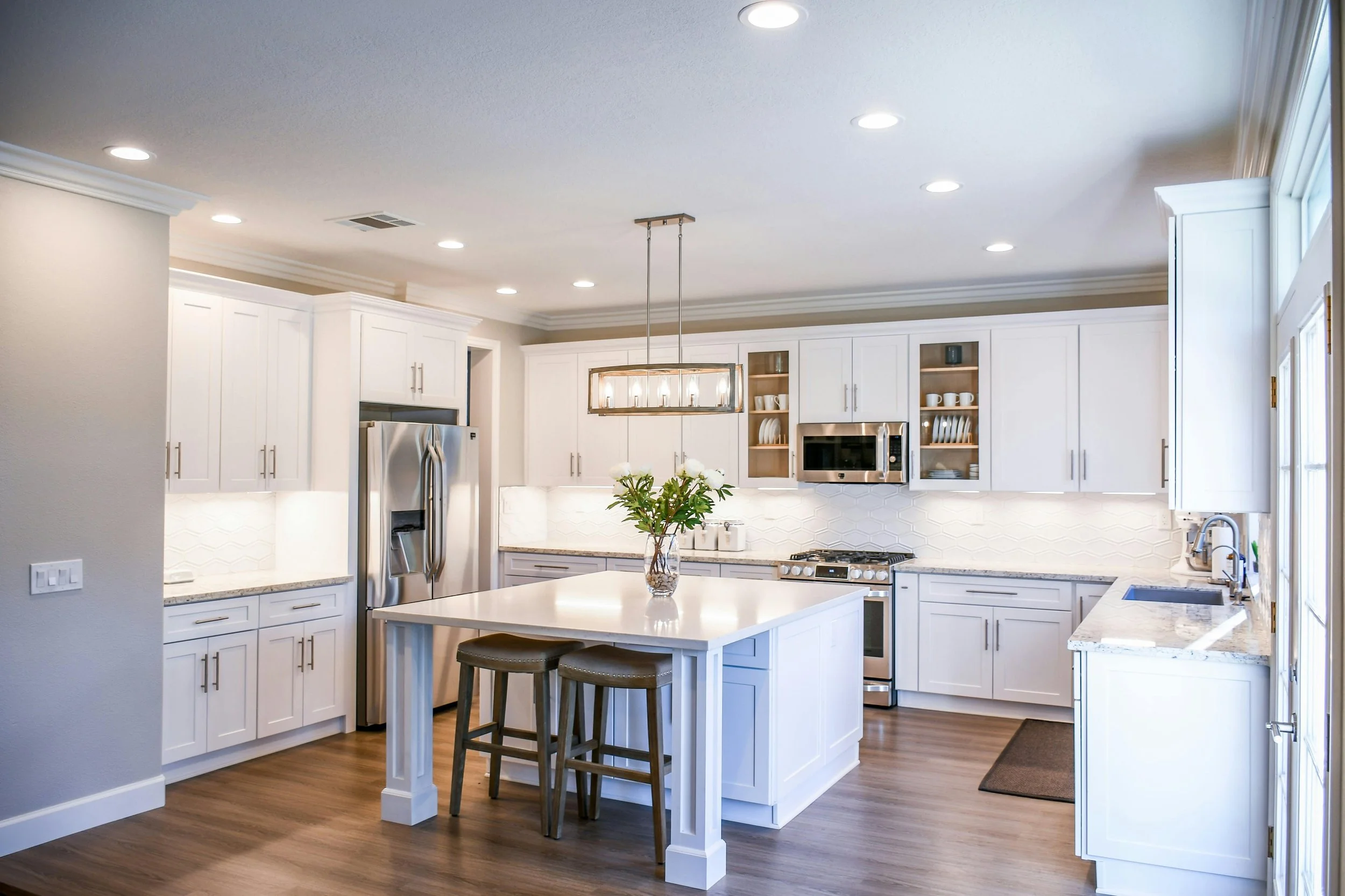 large modern kitchen with island in high gloss finish with wooden floors