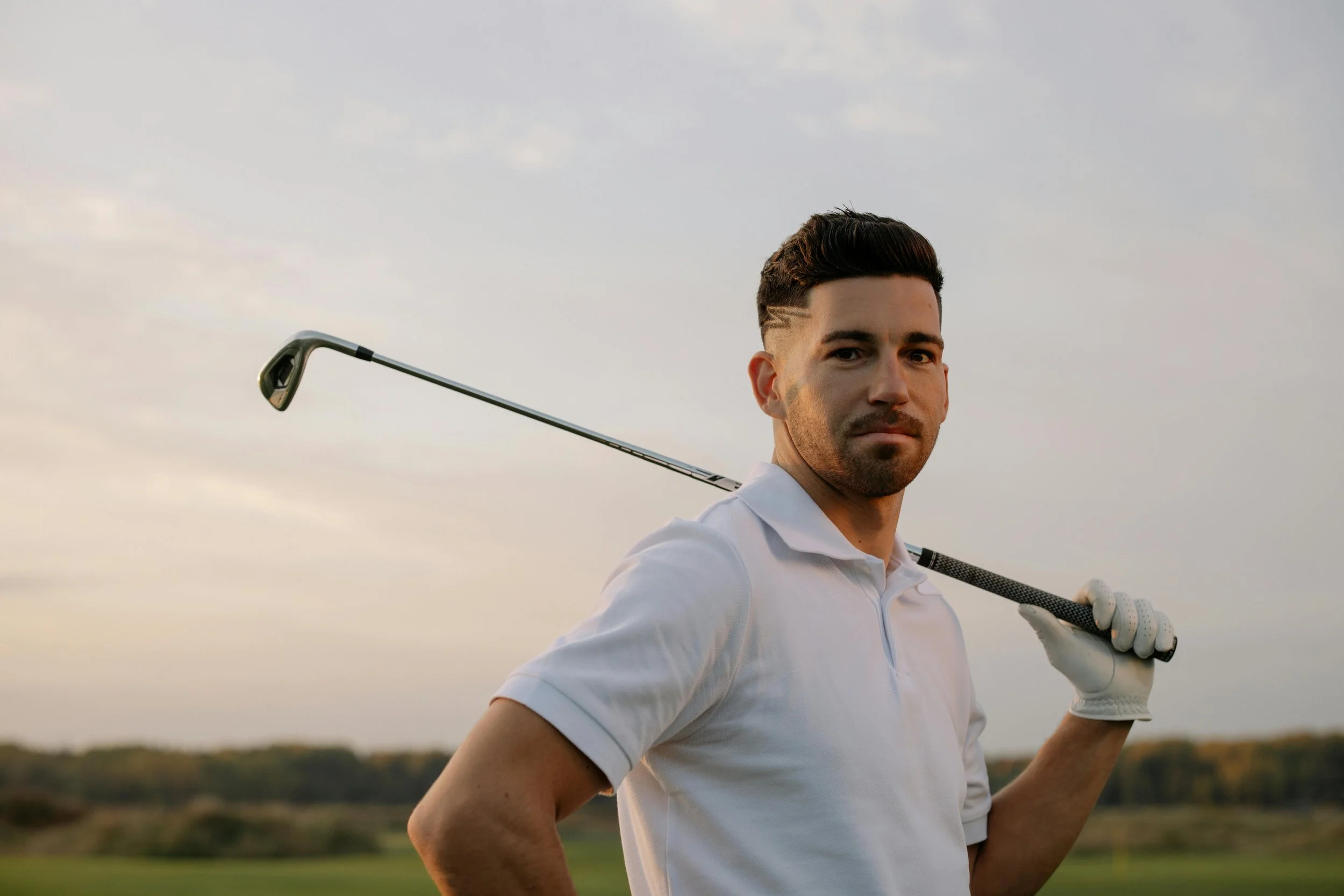 golfer looking at the camera with iron over shoulder