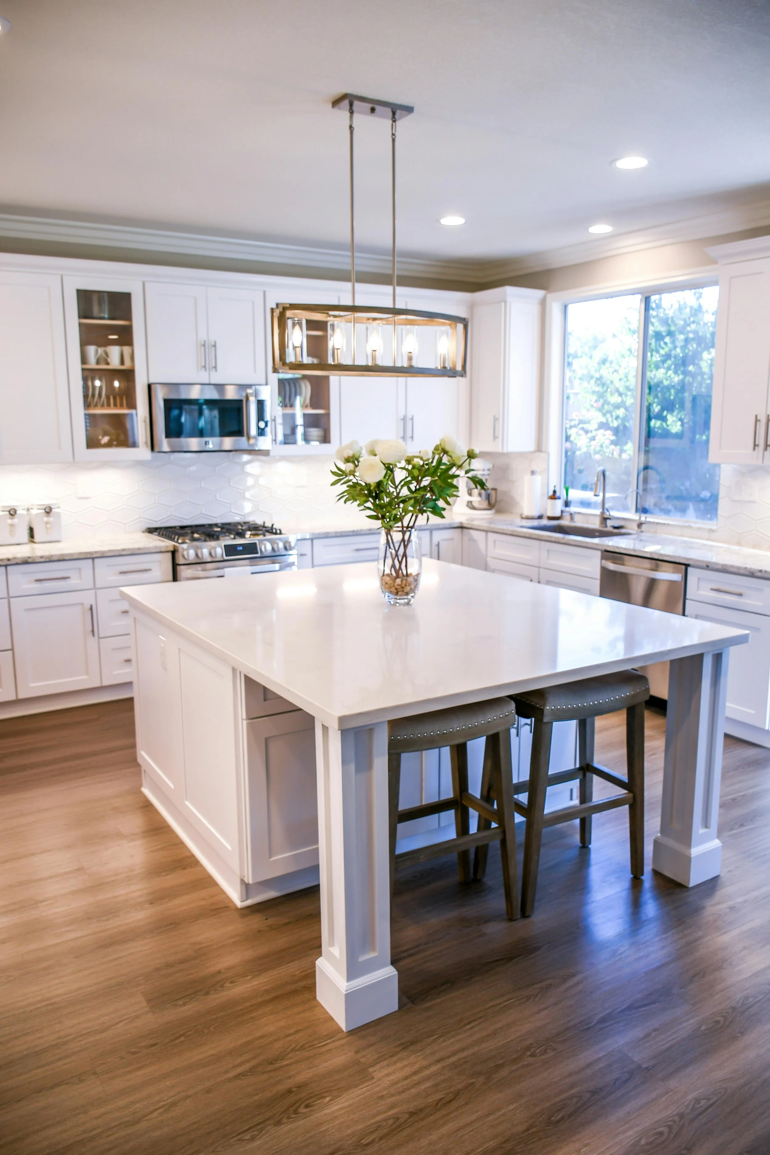 modern white spacious kitchen with wooden laminate floors
