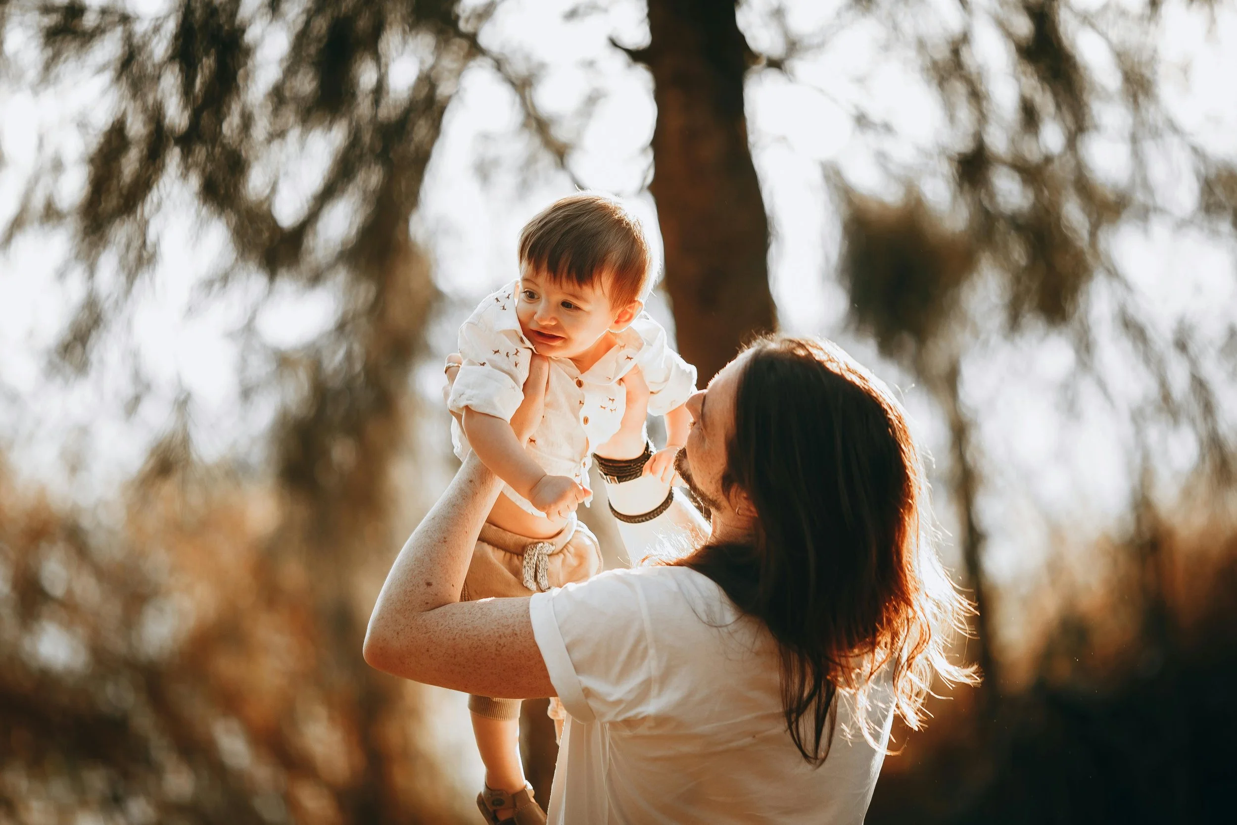 farther lifting his baby up to the sky