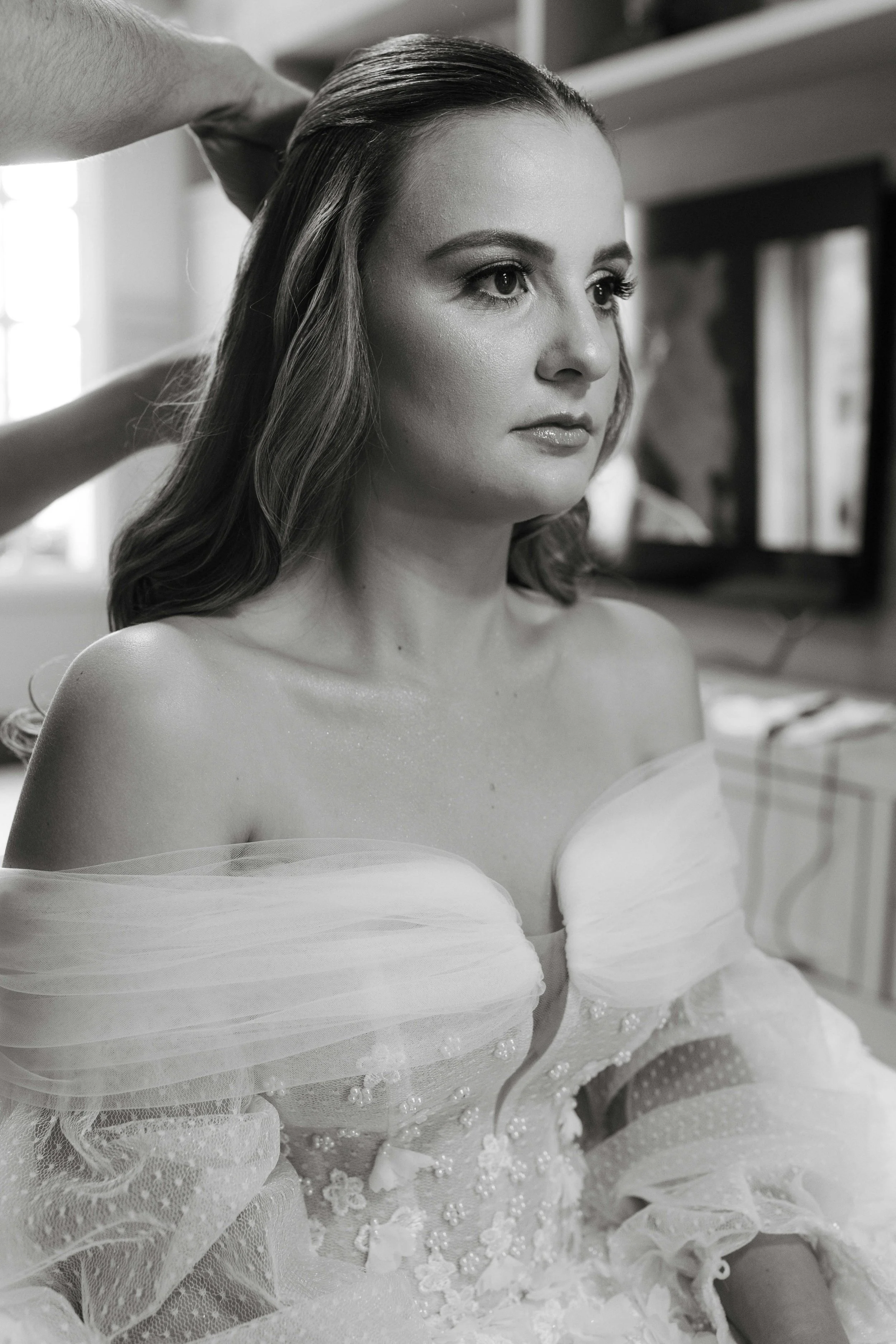 black and white image of bride getting ready on the morning of her wedding day