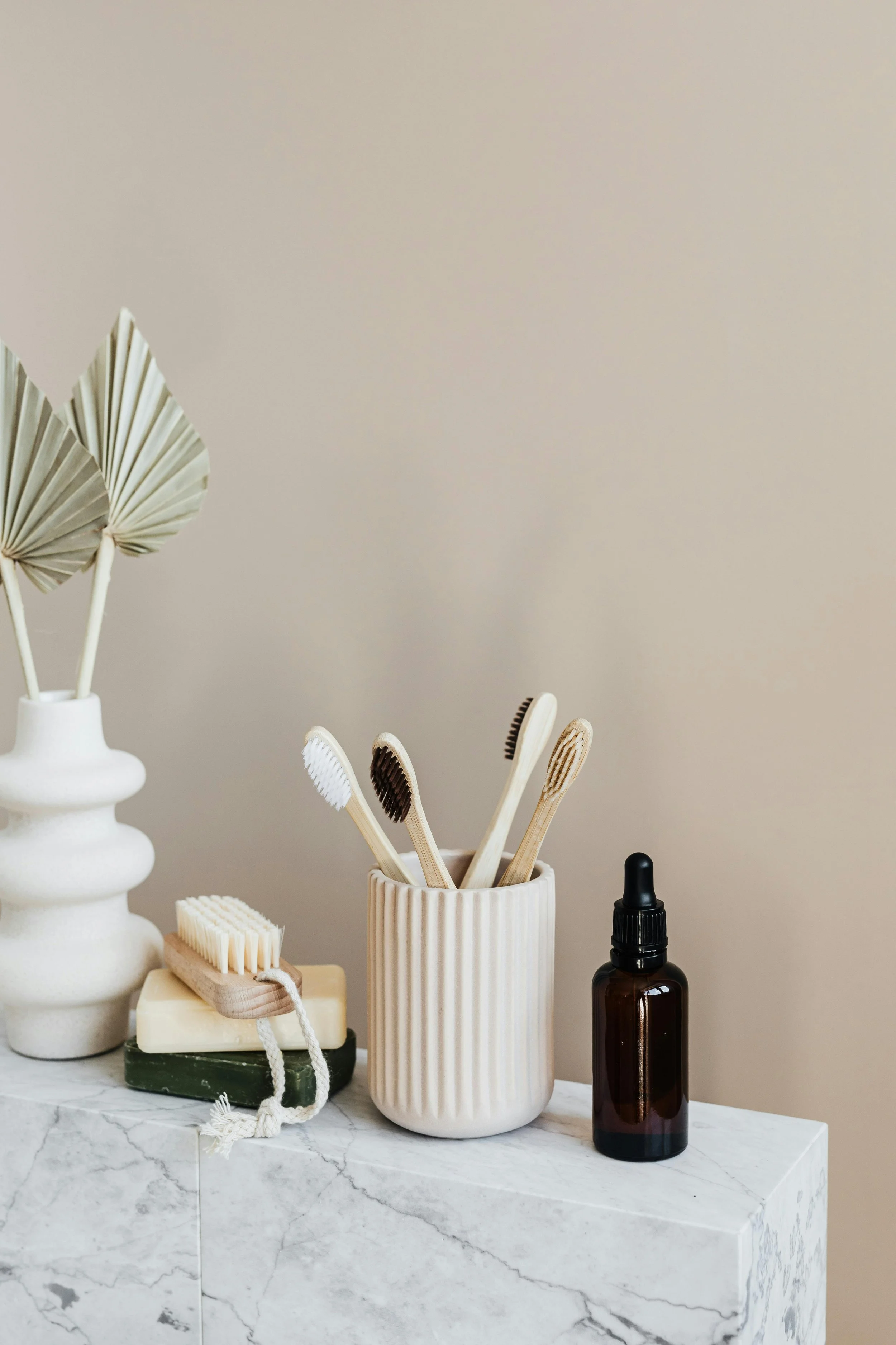 bathroom accessories neatly placed on top of the marble sink