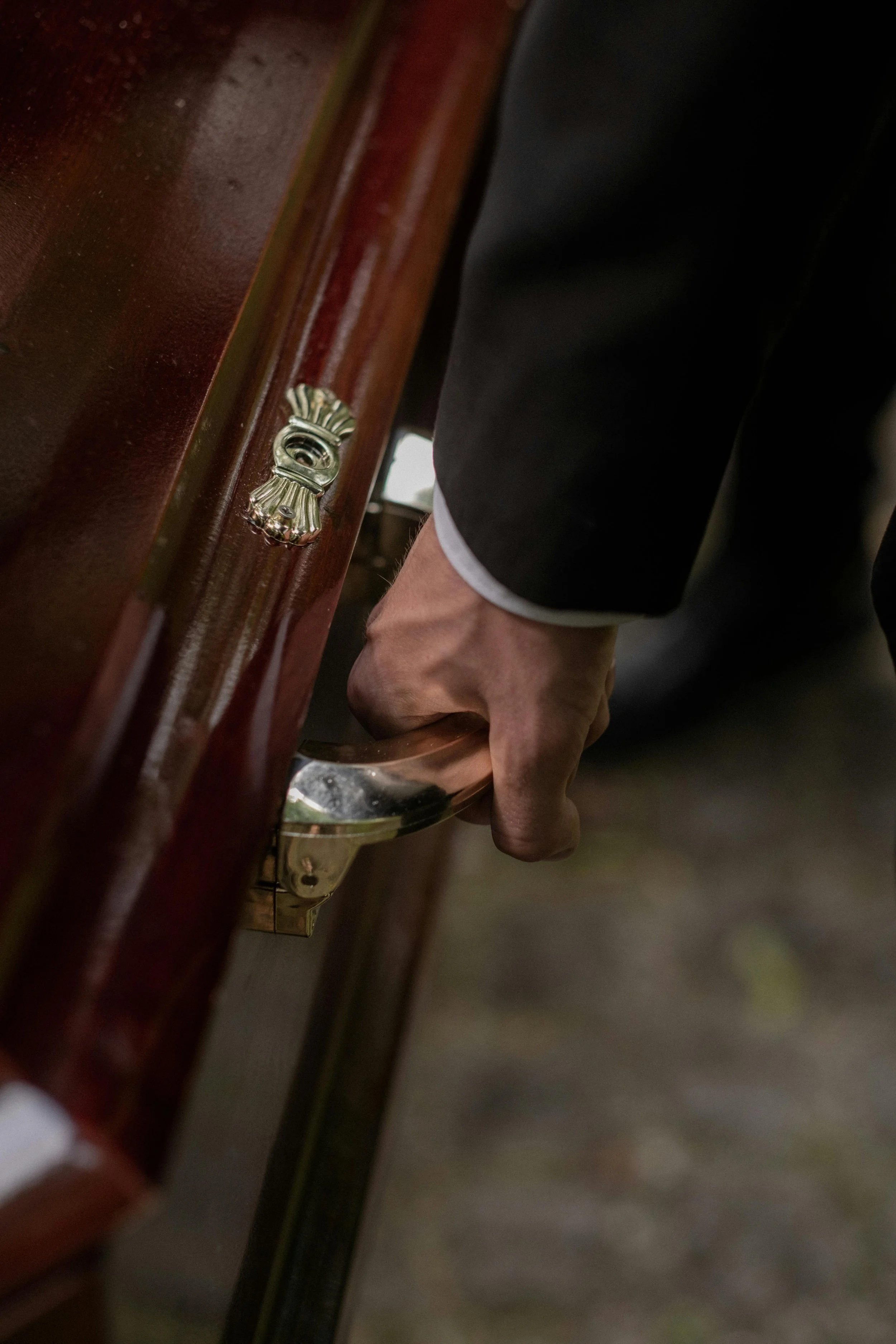 hand-on-coffin-handle