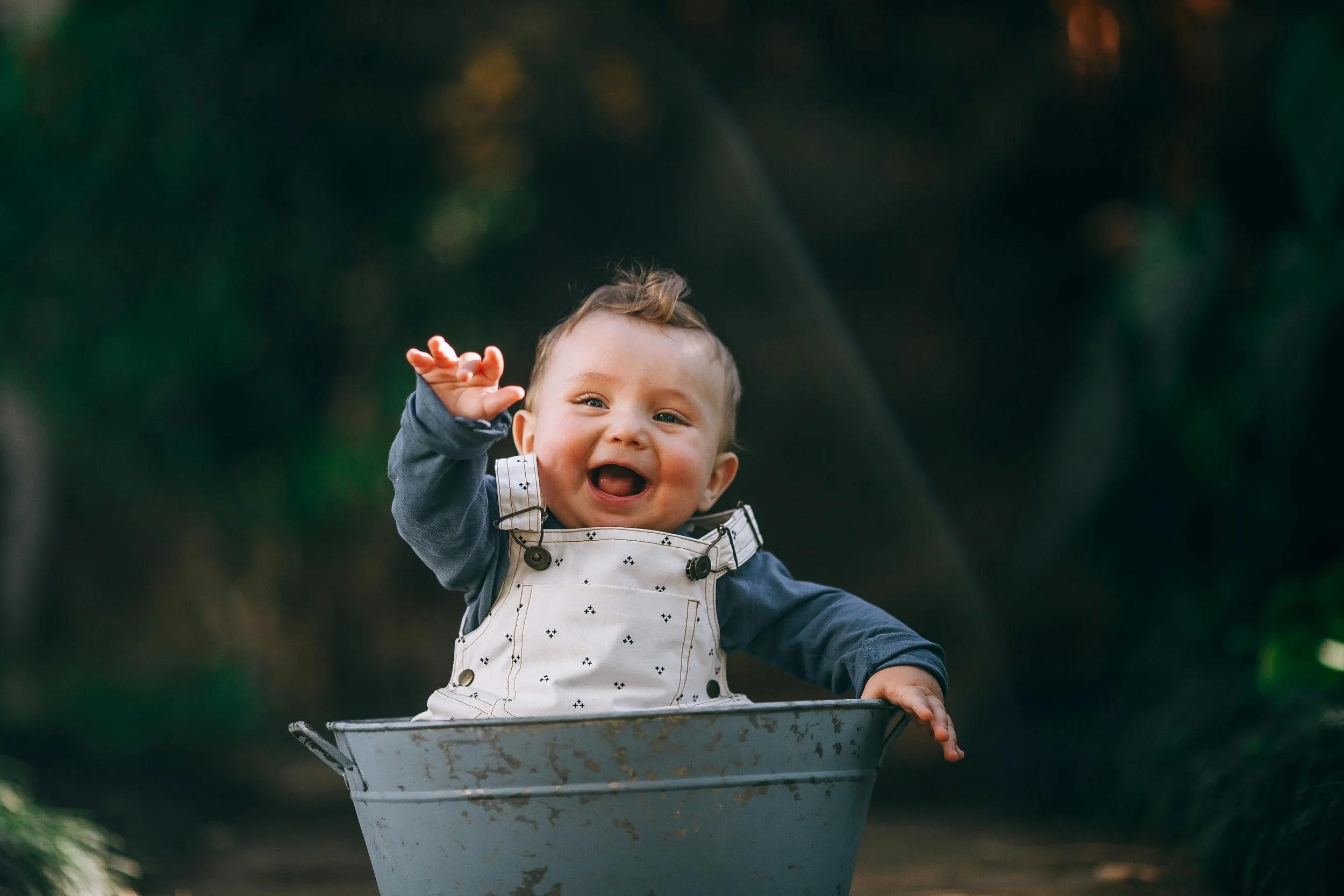 little boy in metal tub happy and laughing