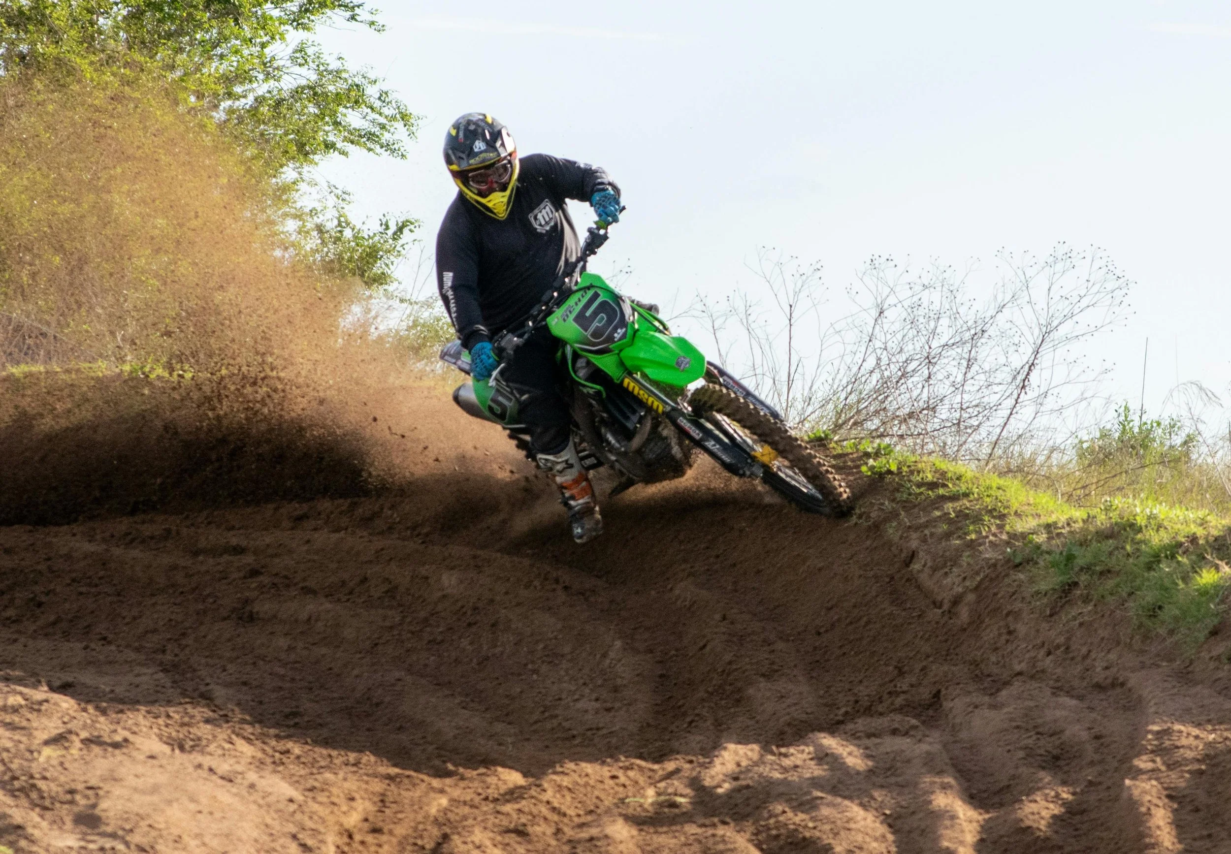 motocross rider coming round the corner on the dirt track