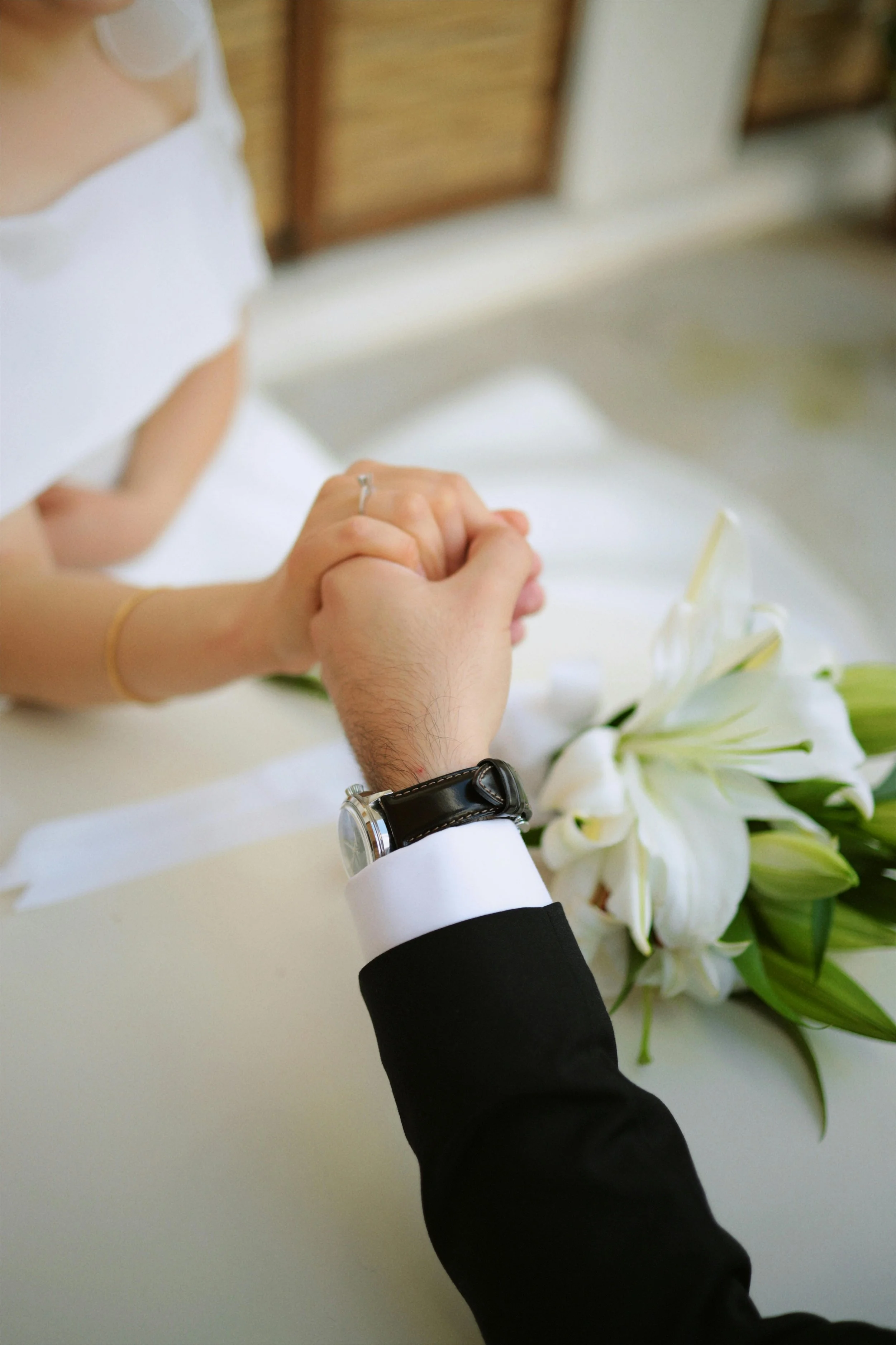 bride and groom holding hands during ceremony