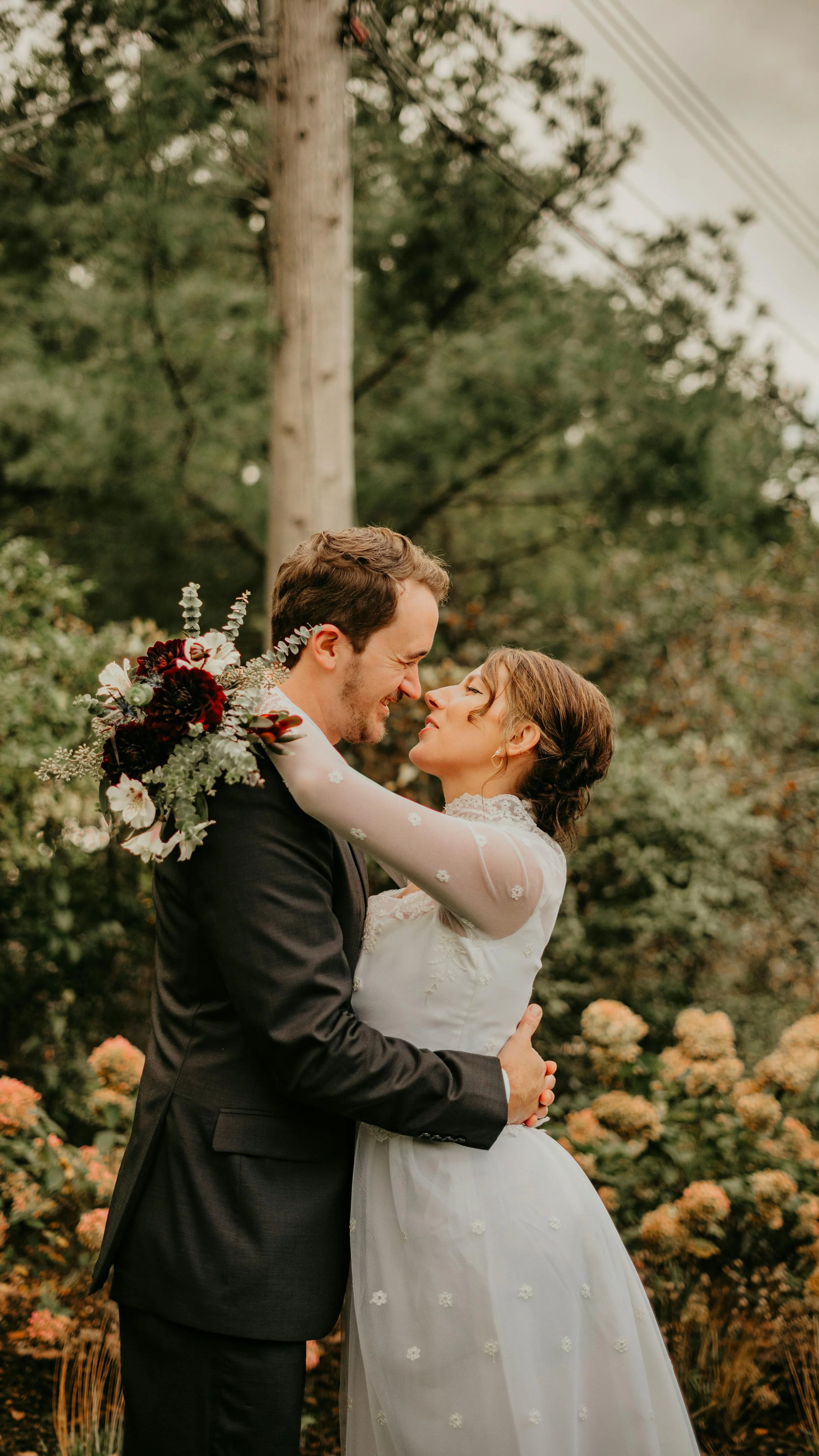 Newley married couple looking into each others eyes with arms around each other