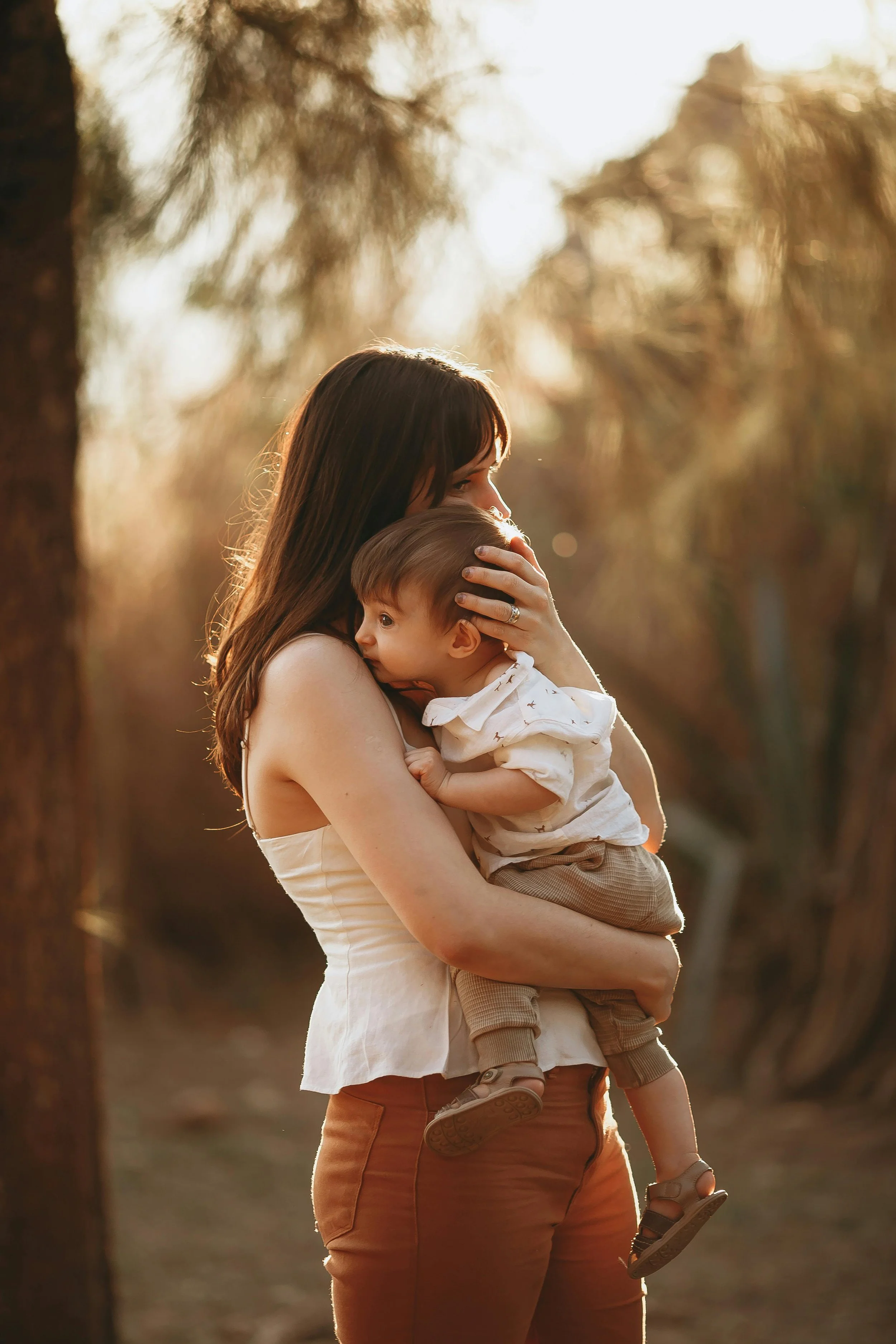 mother holding her baby's head close to her