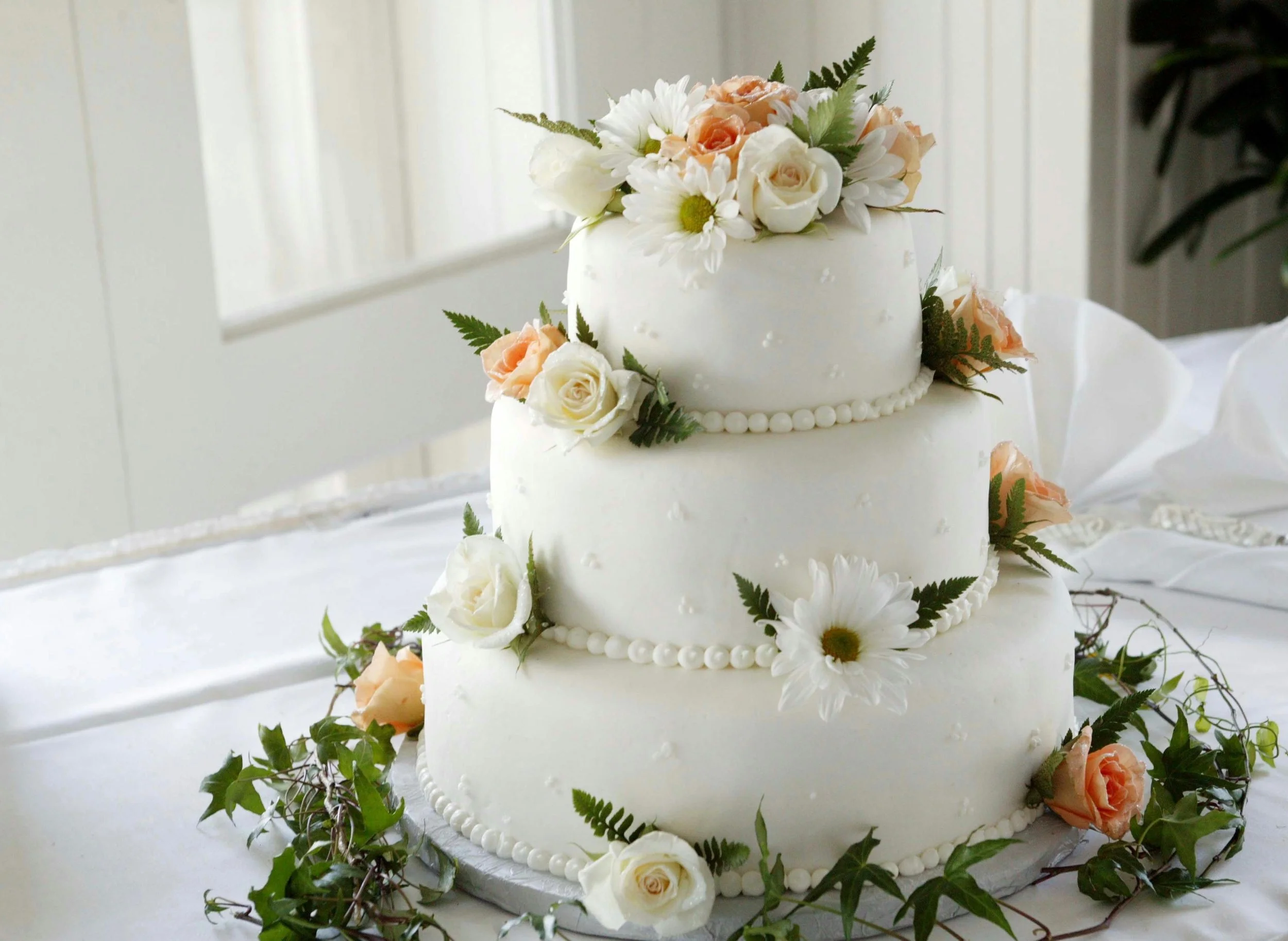 wedding cake with white and orange flowers
