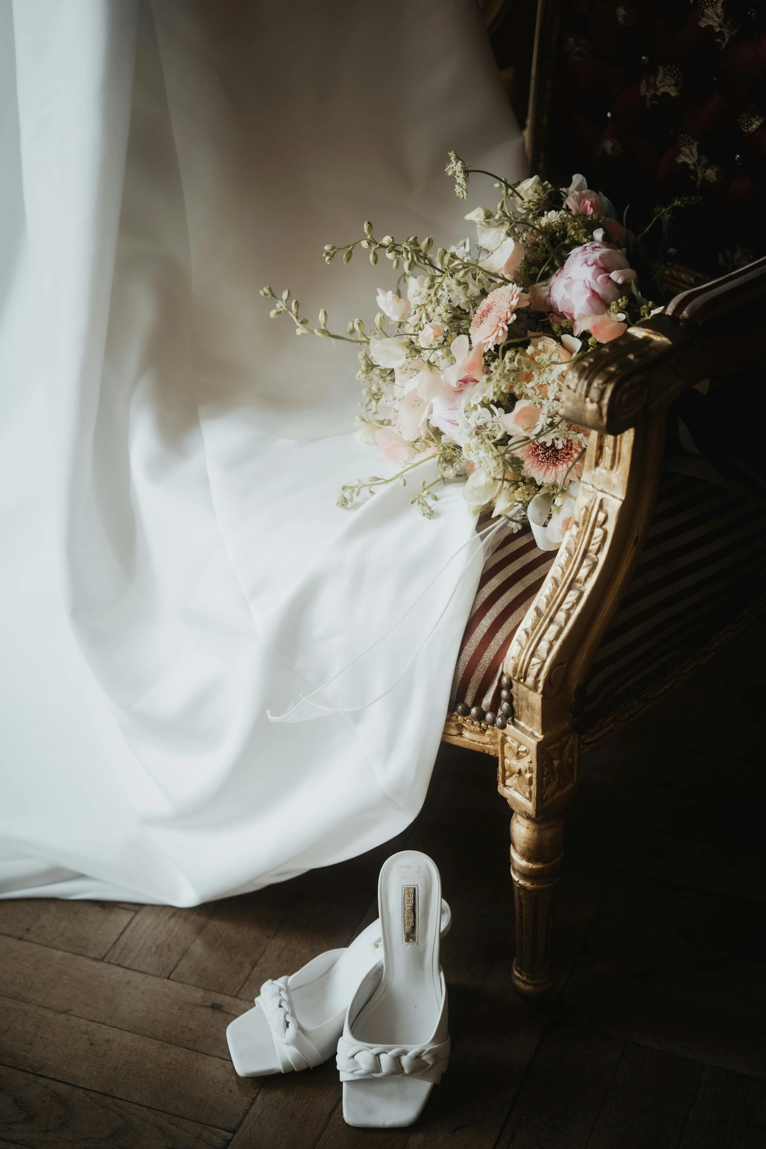 wedding dress with wedding shoes and flowers