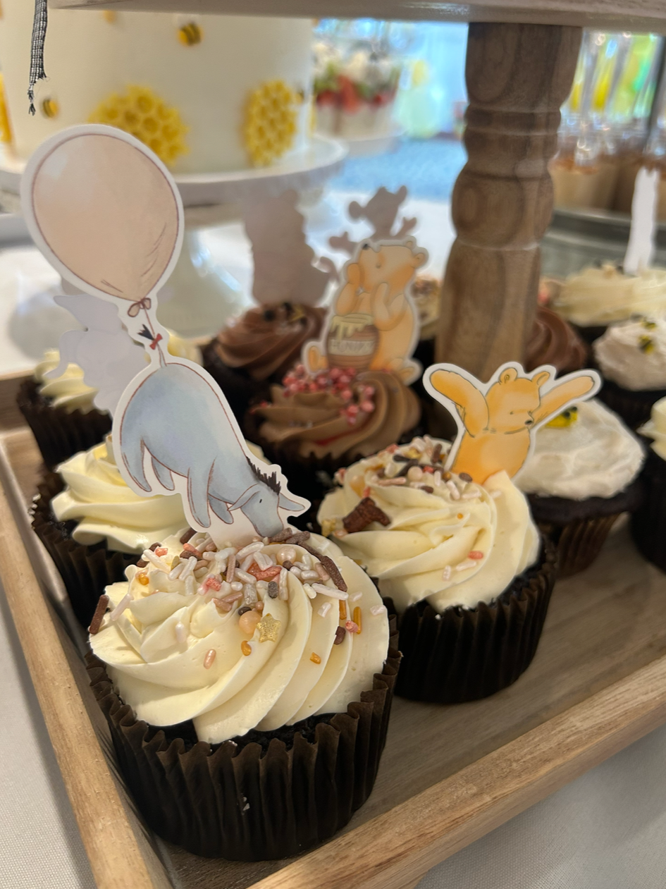 Cupcake arrangement with Winnie the Pooh decorations at country club baby shower.