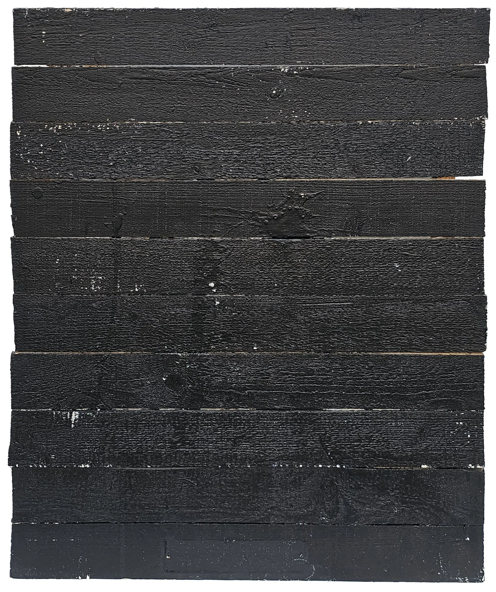 A square wooden surface painted black with some white paint splatters and scratches.