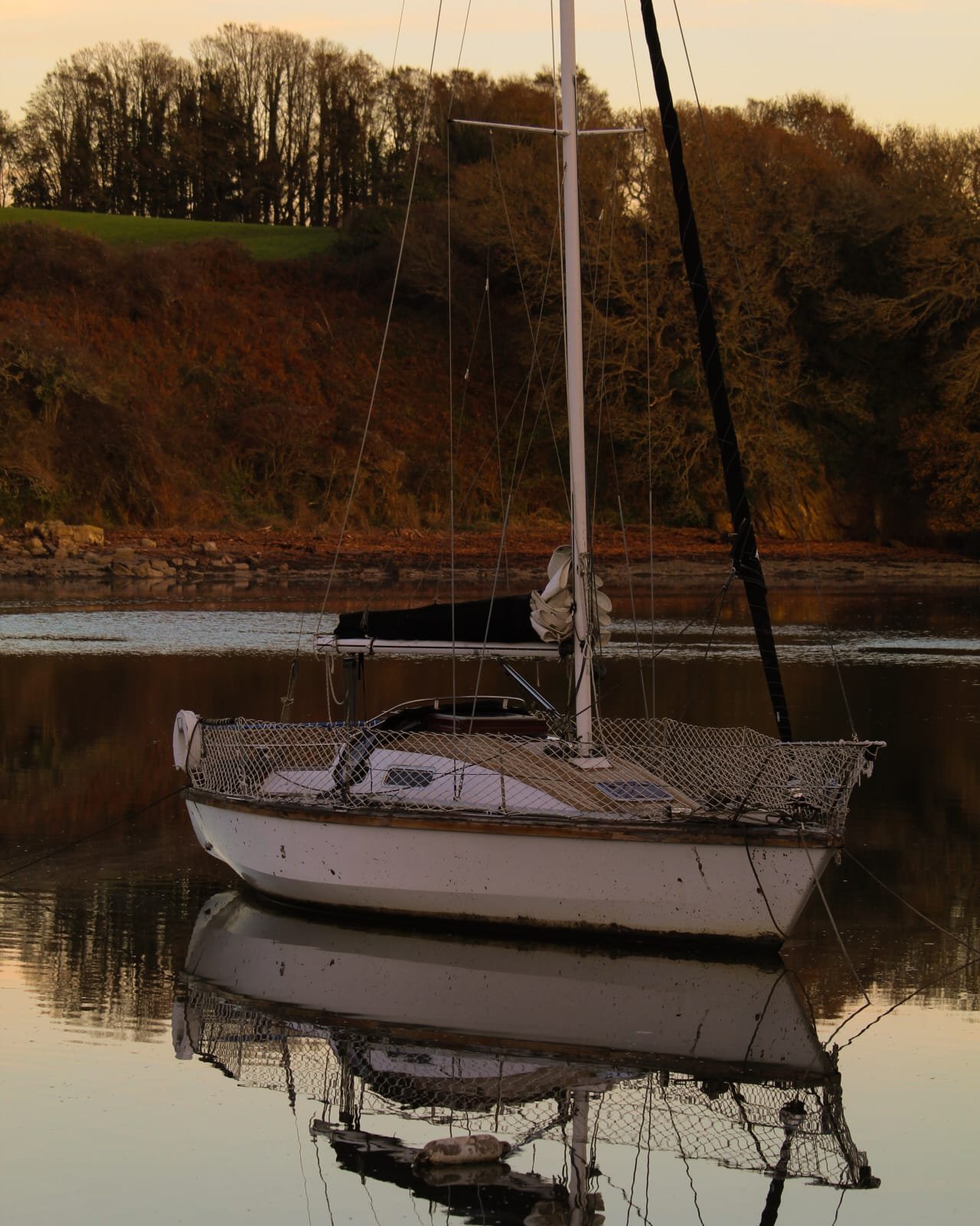 A river in the fading amber light.

The countryside feels most beautiful at dusk &mdash;
When the world exhales.
The sky deepens.
The river slows to a murmur.
And your thoughts finally unwind.

A stillness you can feel &mdash; a quiet unlike anywhere