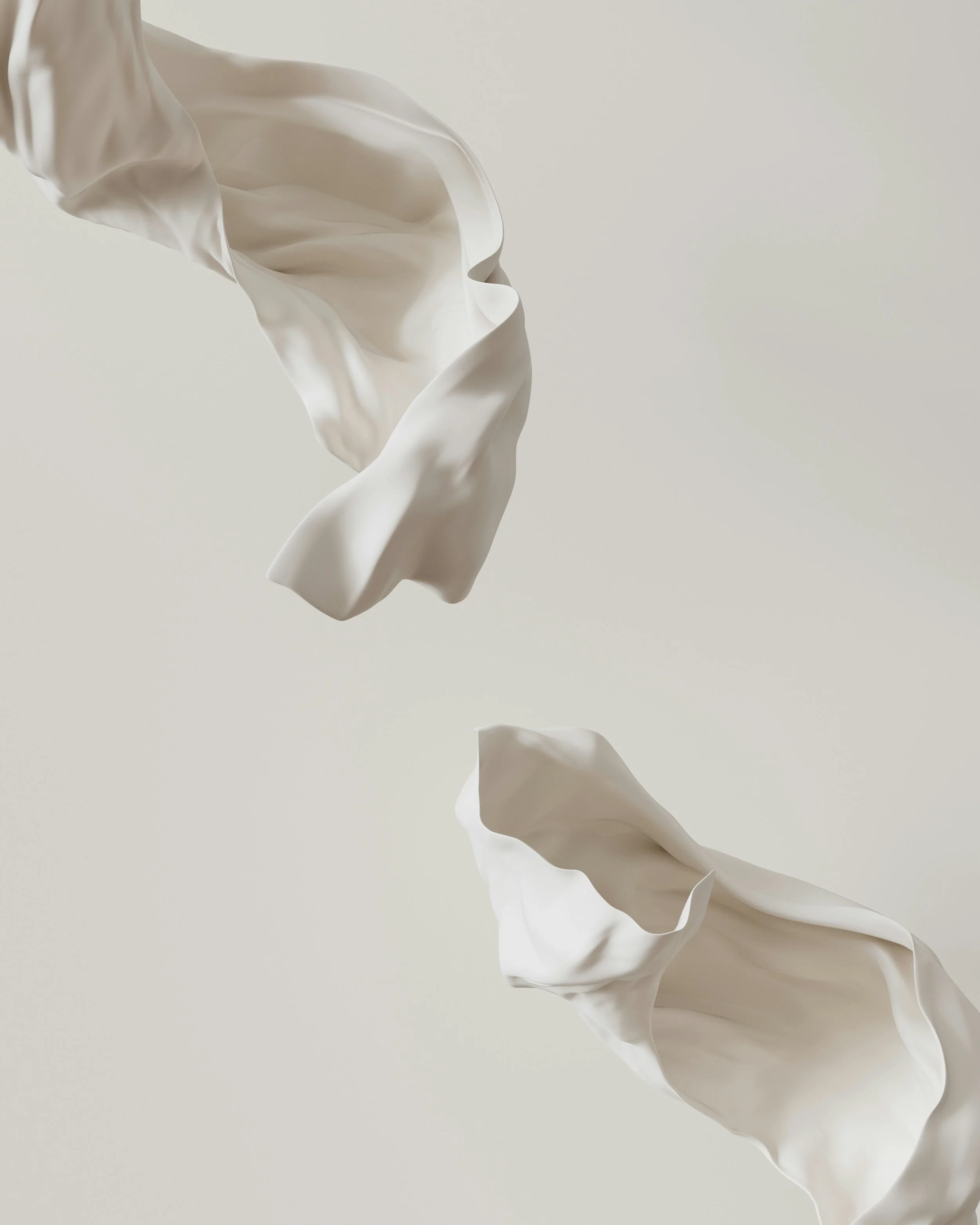 Two white fabric pieces floating in mid-air against a plain background.