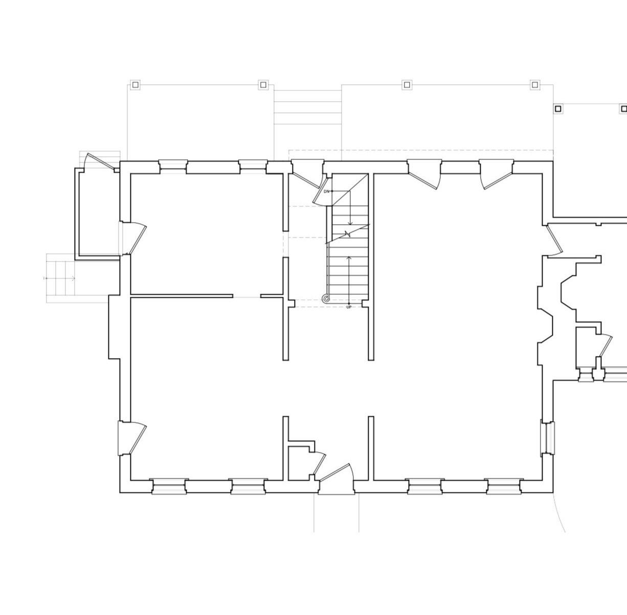 Architectural floor plan with stairs at the center, multiple rooms, and exterior doors.