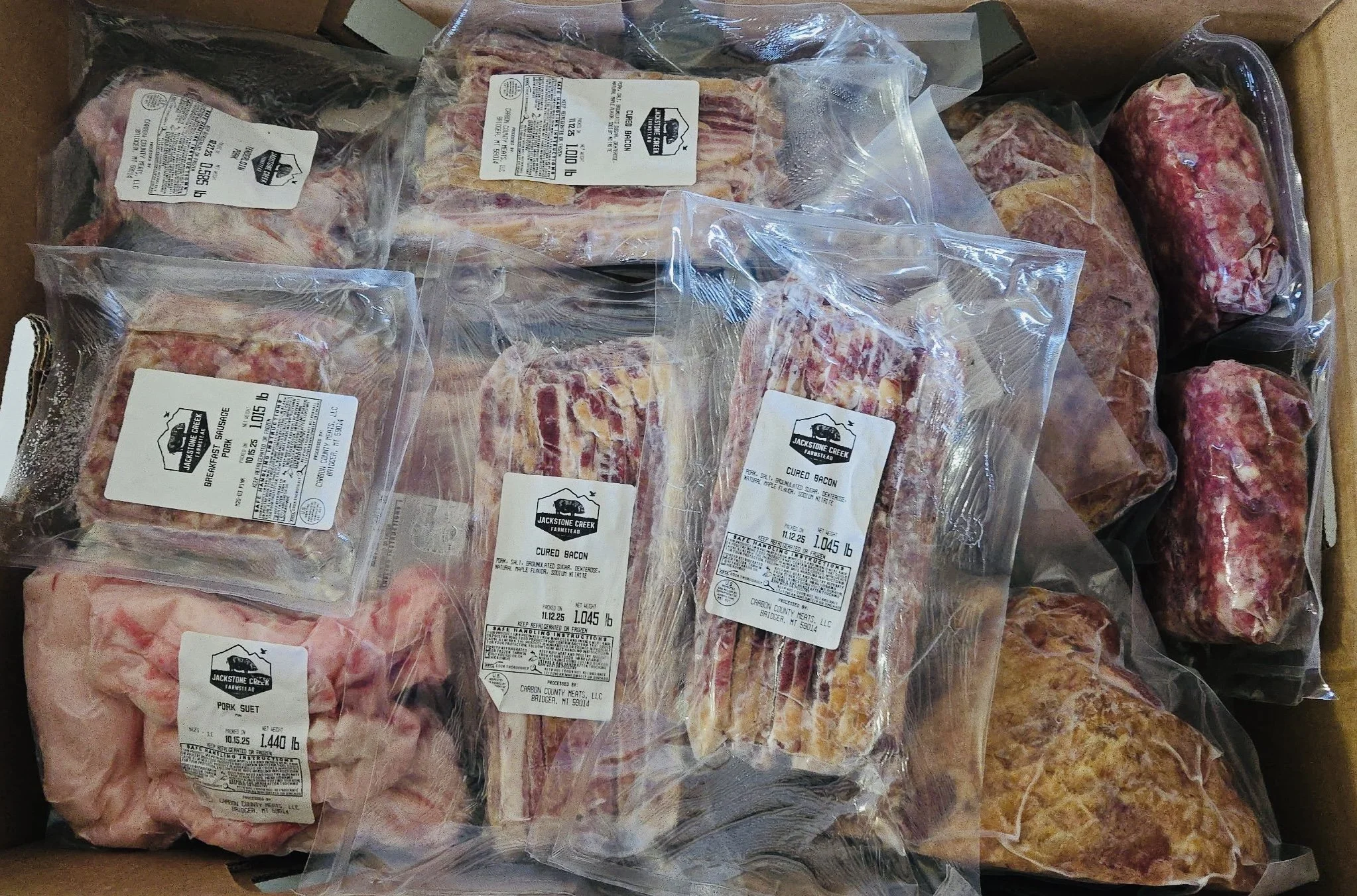 Box filled with various cuts of Meishan pork.