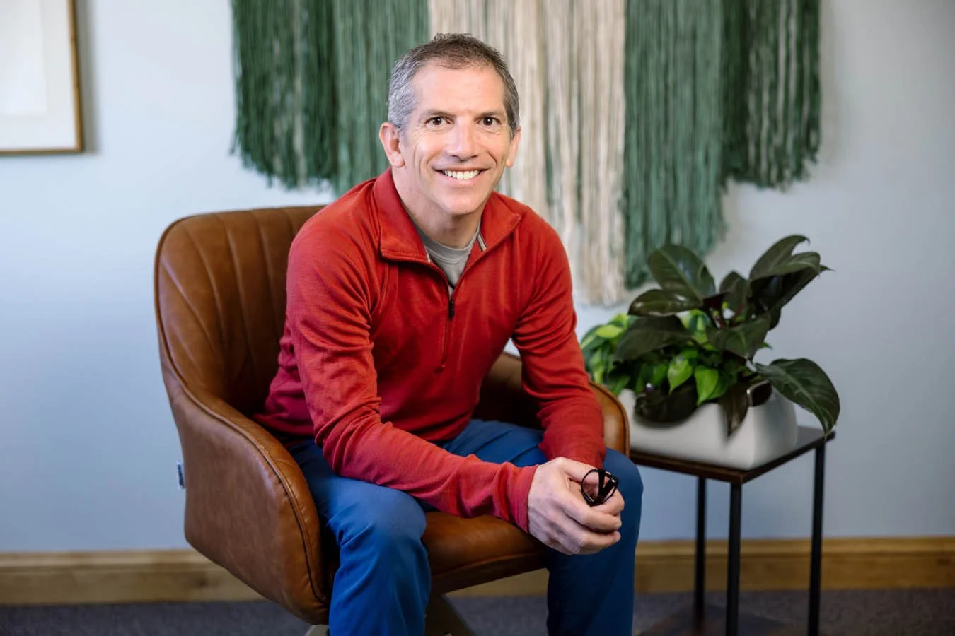 David Lieberman, LMFT on a black sofa in his therapy office.
