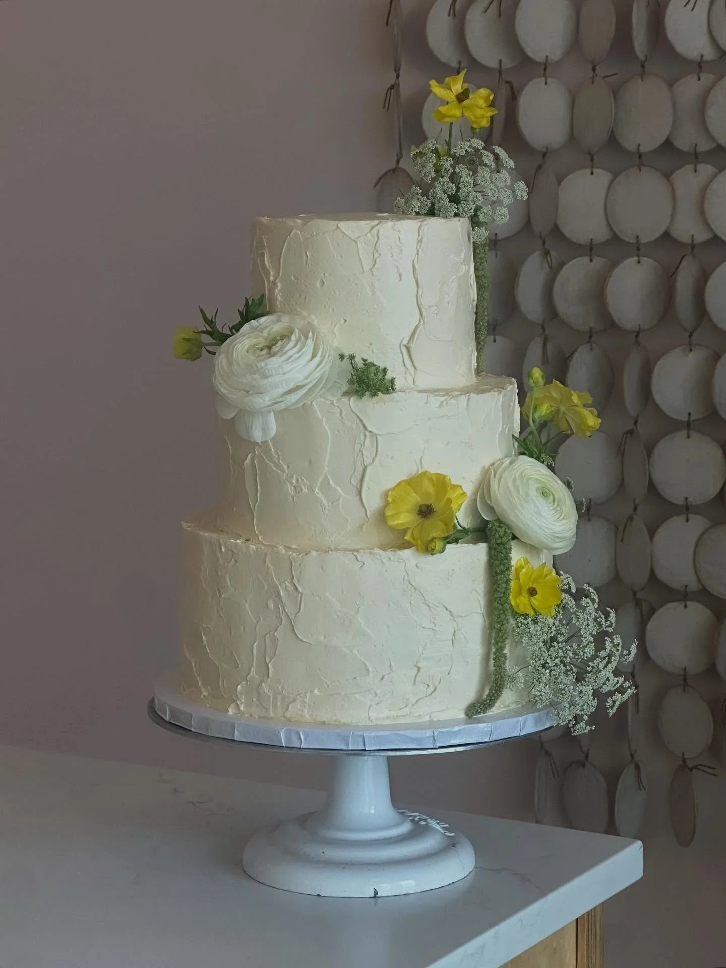 Elegant 3 tier stunner. 💛 Textured, ivory colored &amp; raspberry filled chocolate cake. Congratulations @jen_laurenn!