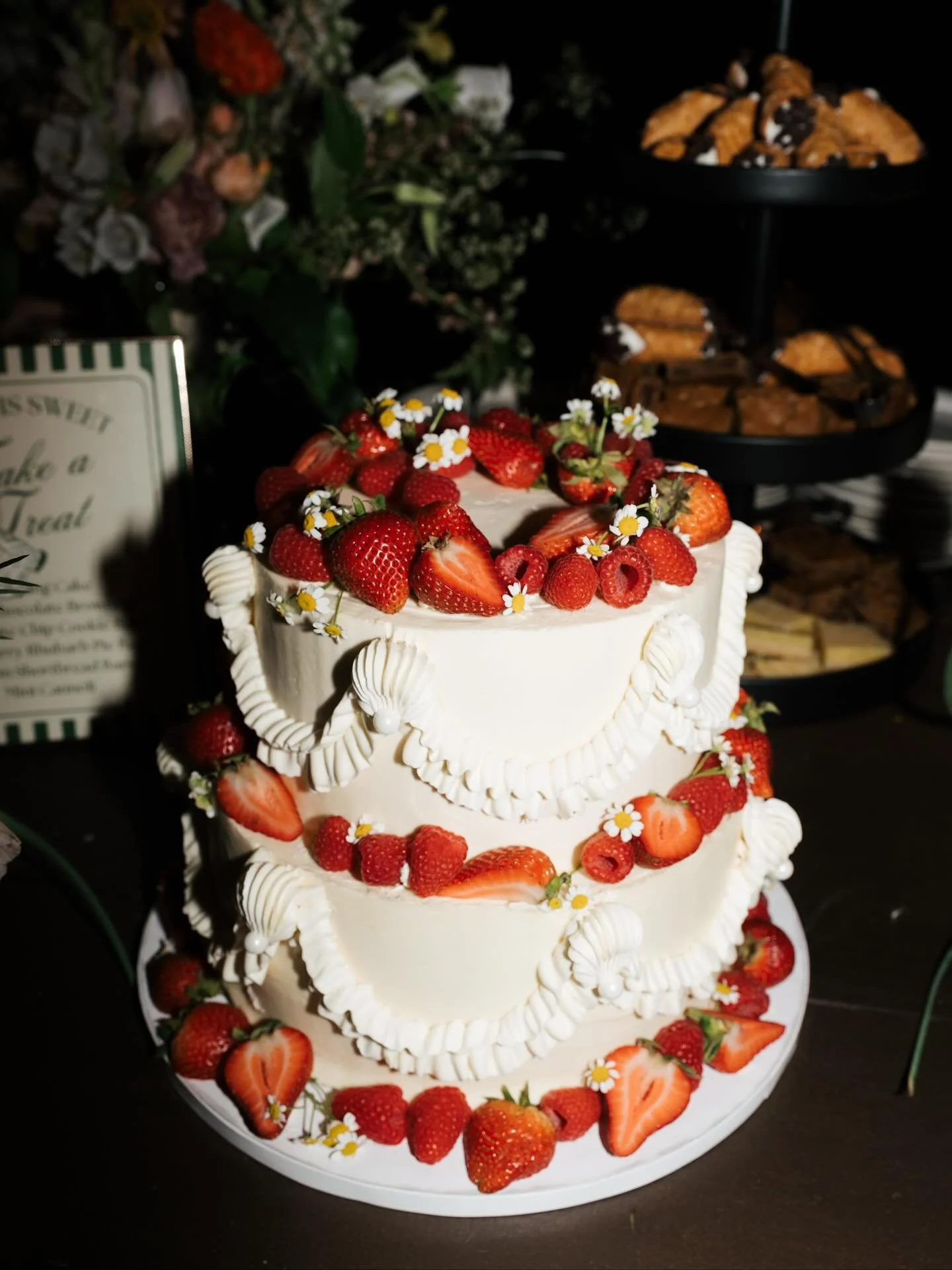 Some gorgeous photos of a beautiful wedding by @elangbamphoto, one of our favorite cakes from this summer. This was a Citrus Olive Oil Cake with some piping, fresh berries &amp; chamomile flowers. We love to see our cake&rsquo;s big moment!! 😍🥹
