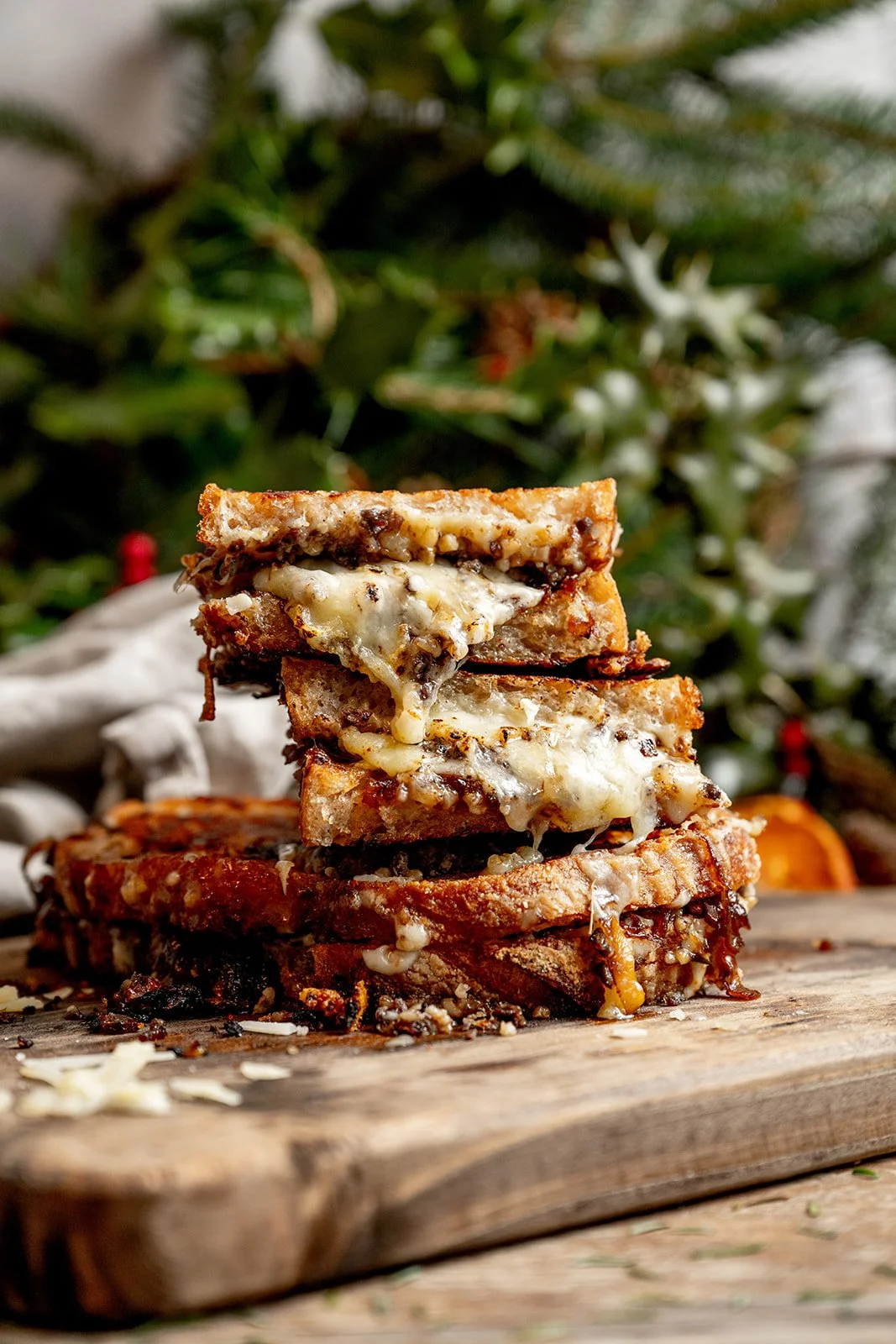 Close up of haggis toastie cross-section showing layers of melted cheese, crumbled haggis and sticky whisky shallots