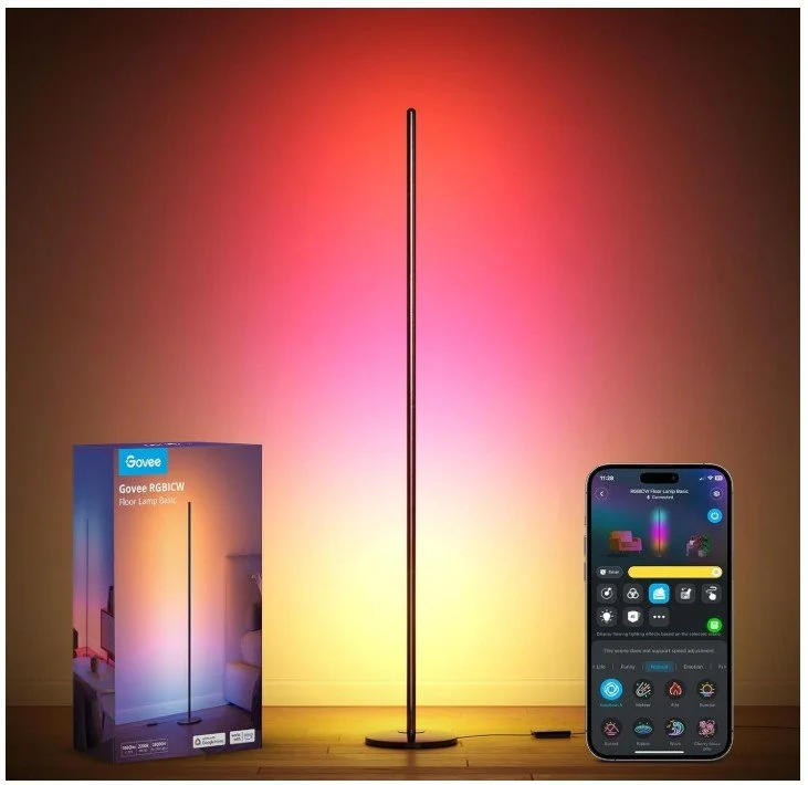A smart floor lamp displaying colorful RGB lighting, placed next to its packaging and a smartphone controlling the lamp's settings.