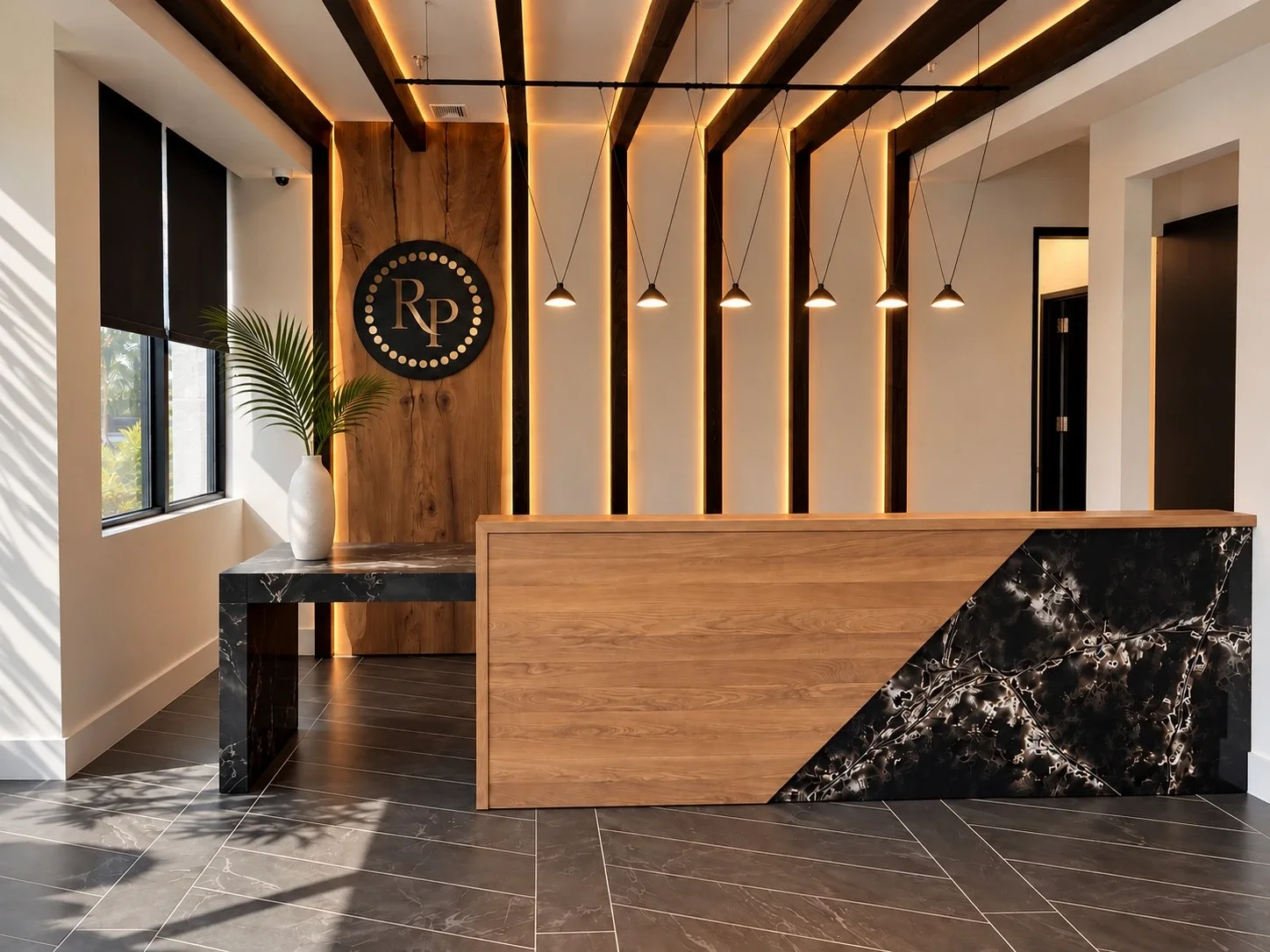 Custom Rocky Patel reception area by Domina Design featuring a bespoke wood and marble reception desk, integrated lighting, and architectural wood detailing.