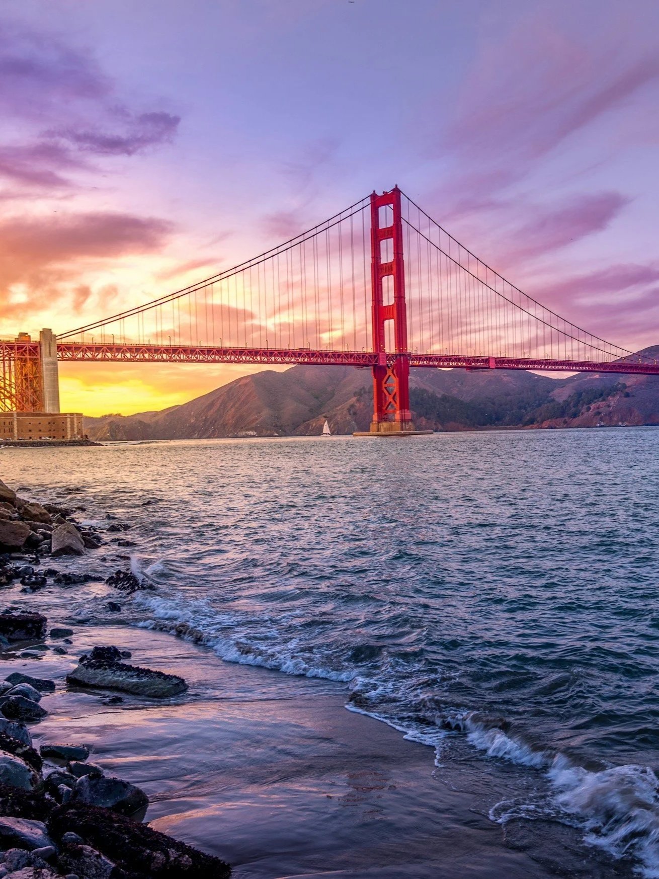 Golden Gate bridge with the Sun rising in the background