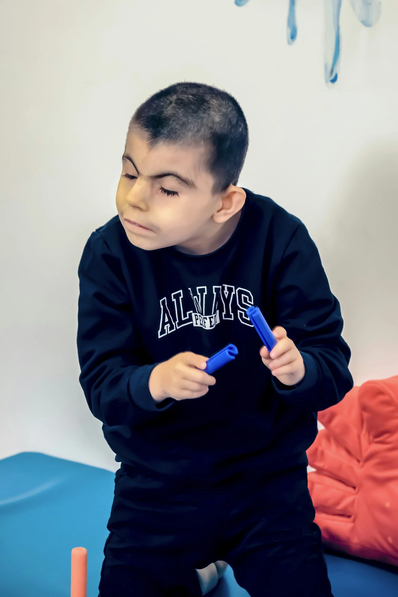 Boy holding fidget tubes