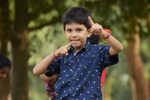 Boy holding his hands up in the air