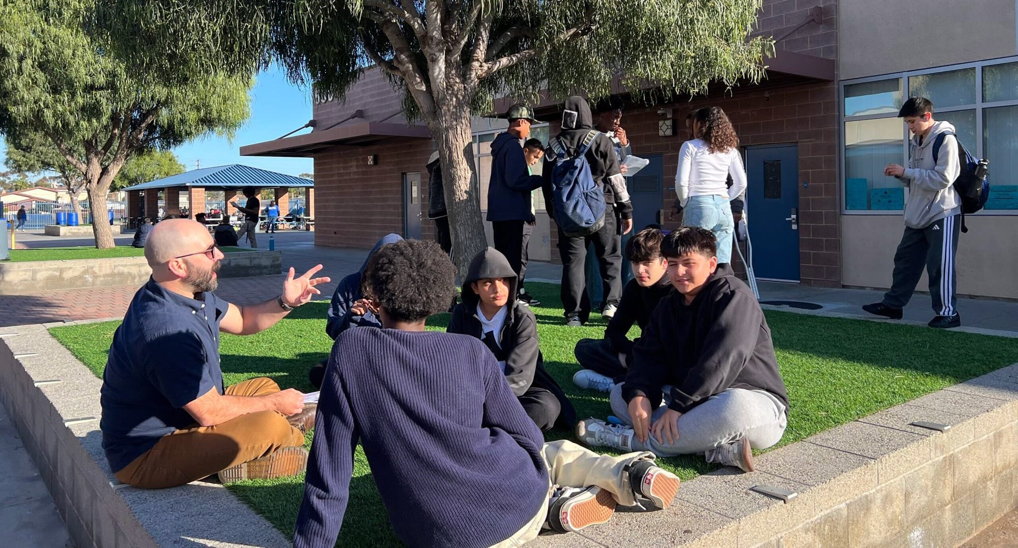 Russell Stoll collaborates with students at AI hackathon