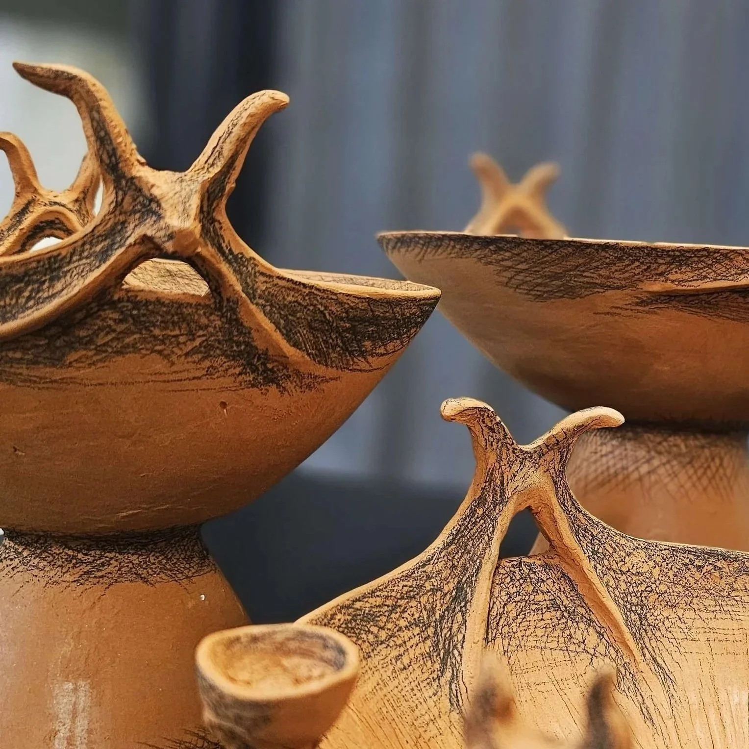 Detail of black underglaze pencil decoration on terracotta ceramic vessel