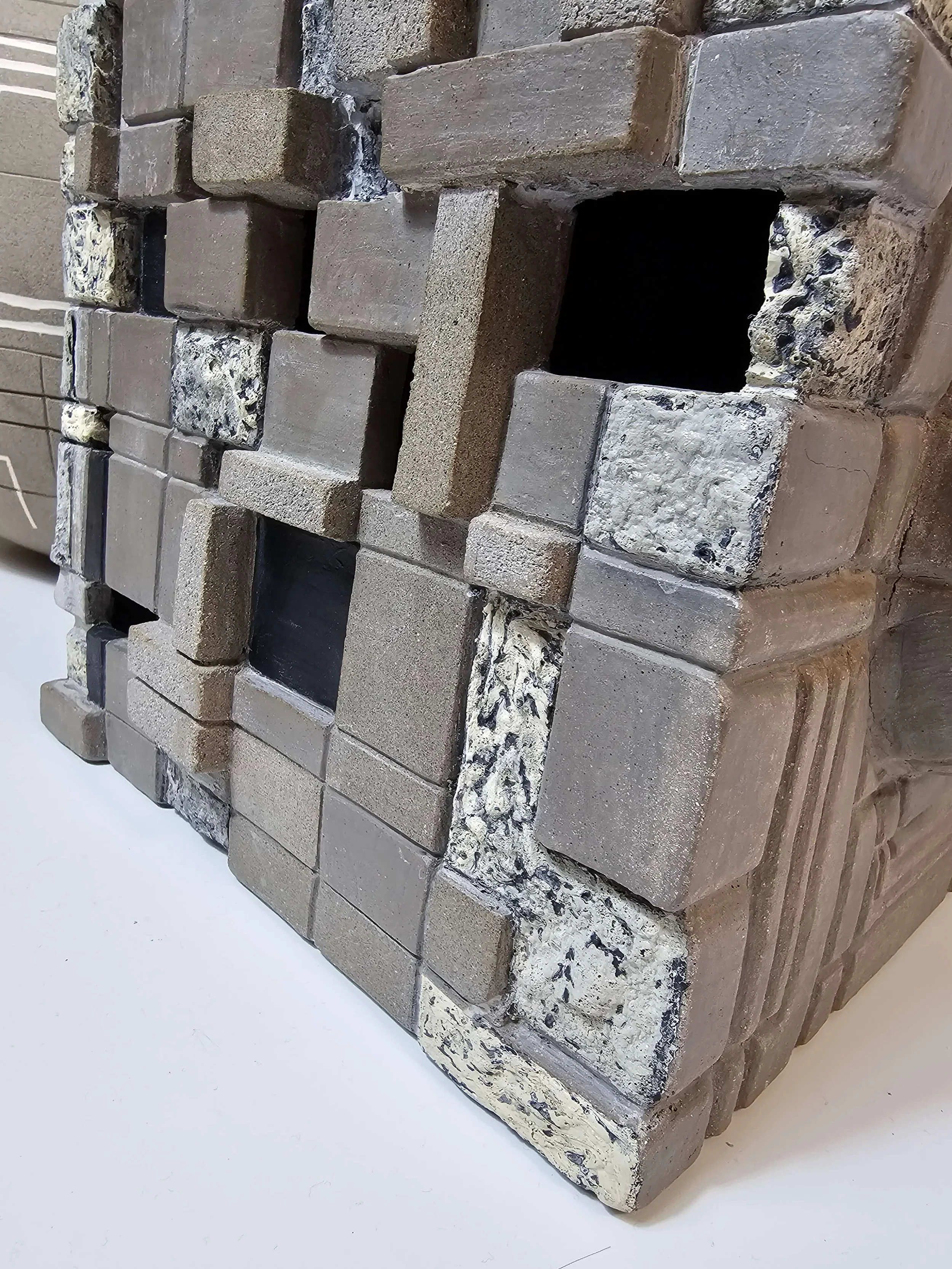 Hand-built ceramic sculpture in porcelain and stoneware questioning creativity, ownership, and artistic expression.
