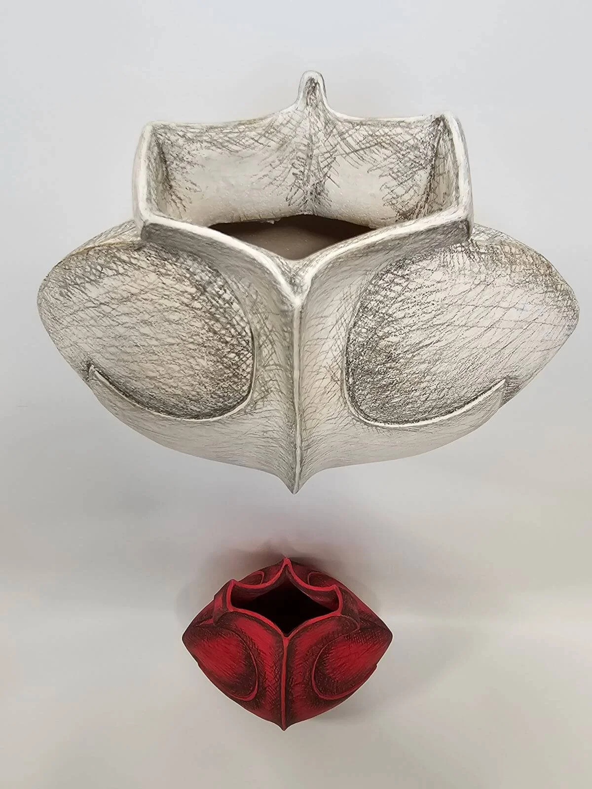 Vital Exchange contemporary ceramic installation with two shield-like stoneware vessels