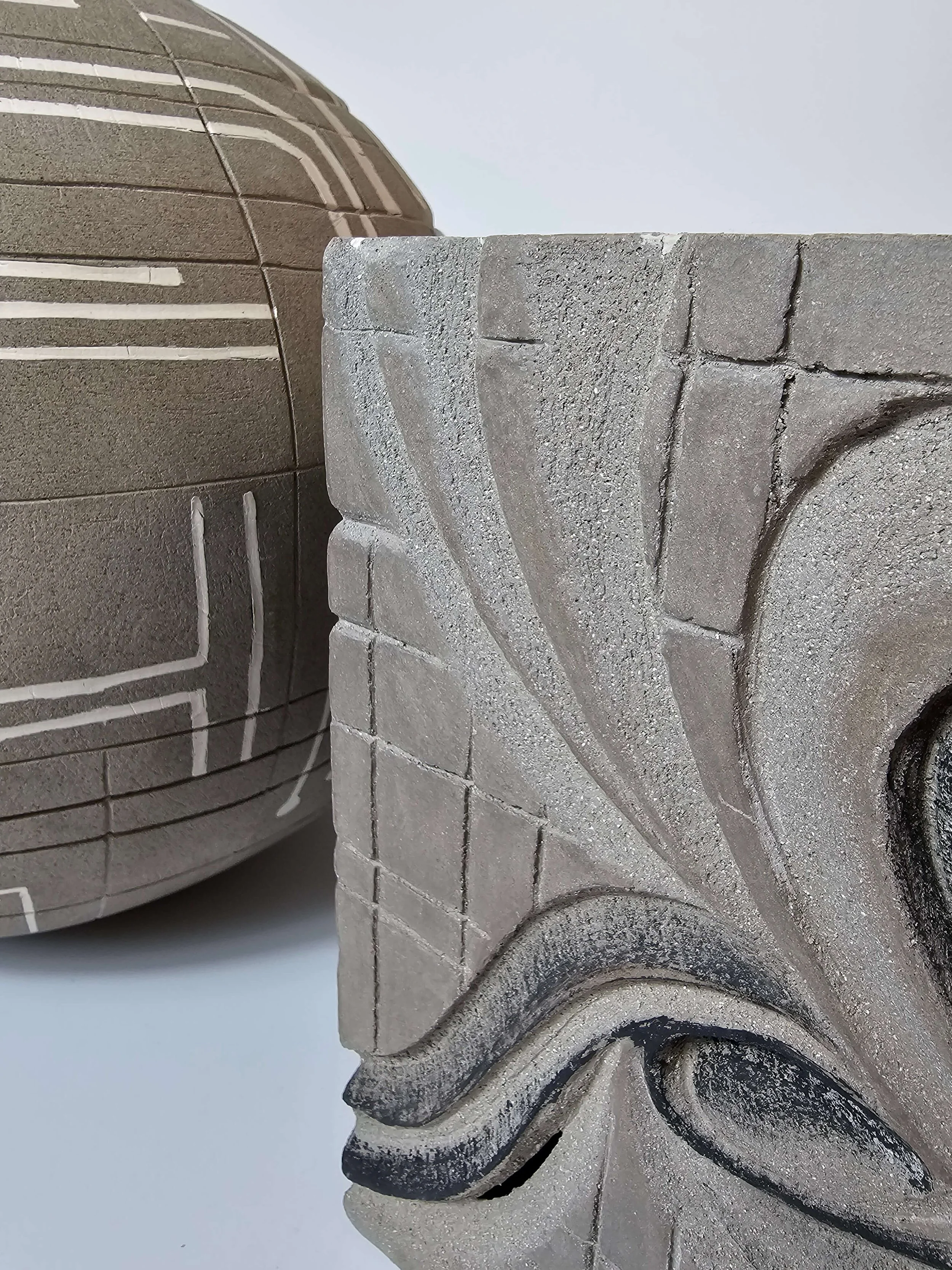 Hand-built ceramic sculpture in porcelain and stoneware questioning creativity, ownership, and artistic expression.