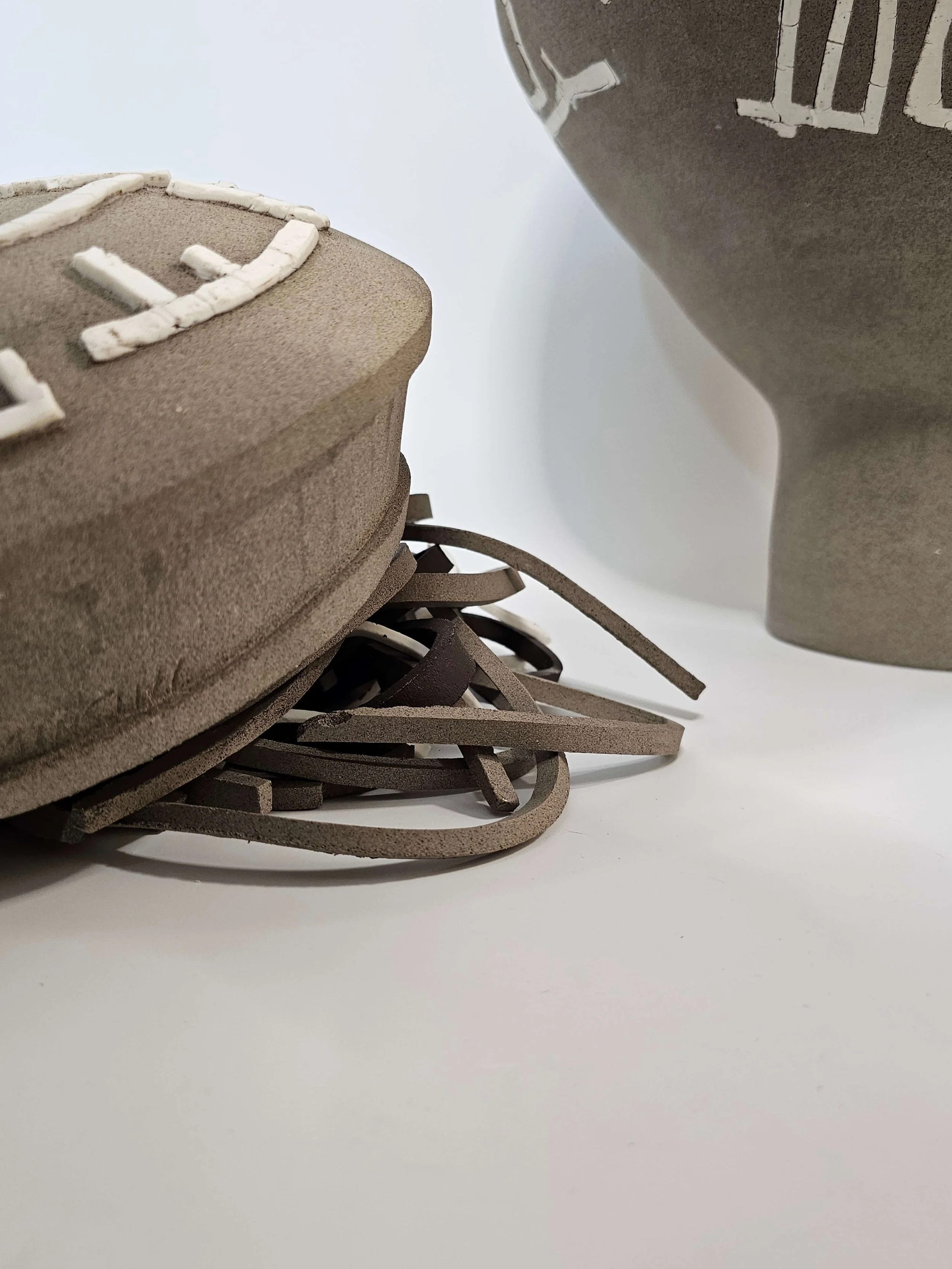 Ceramic sculptural form with carved surface and porcelain elements inspired by Dimitris Pikionis