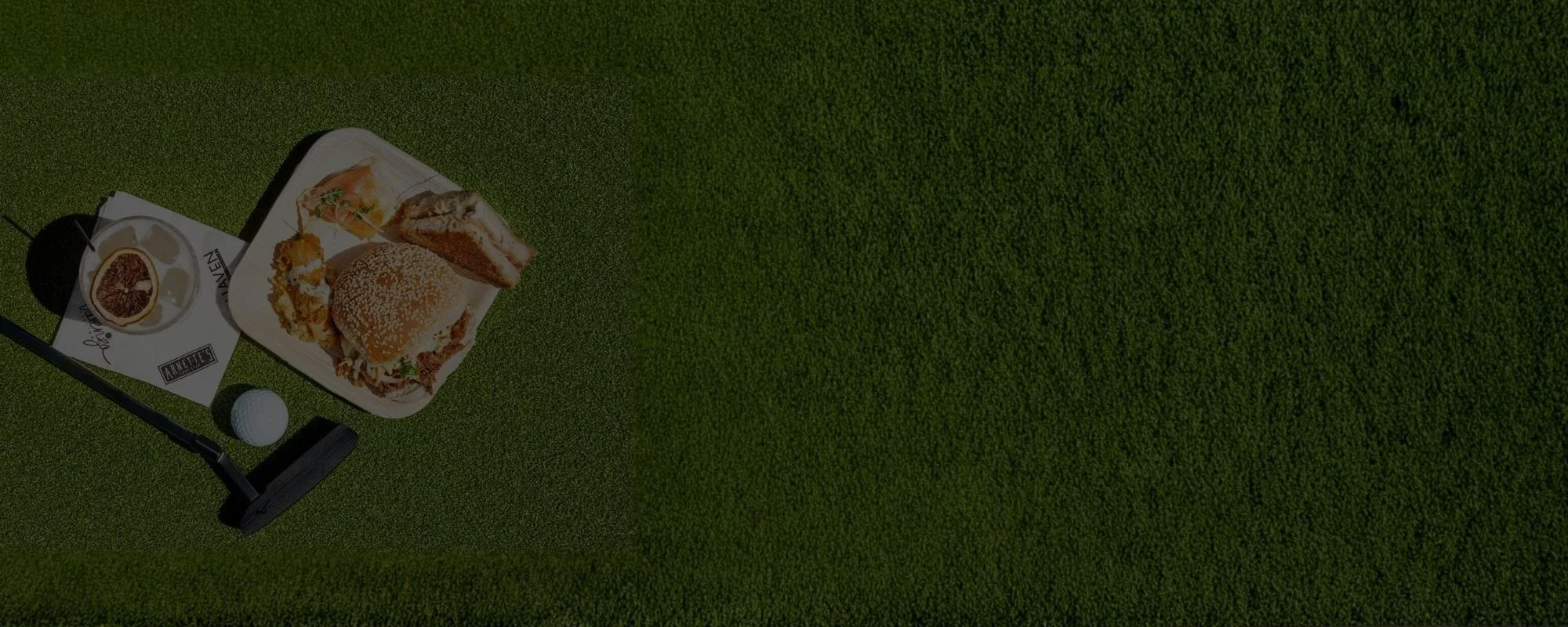 Golf green with a ball and putter.